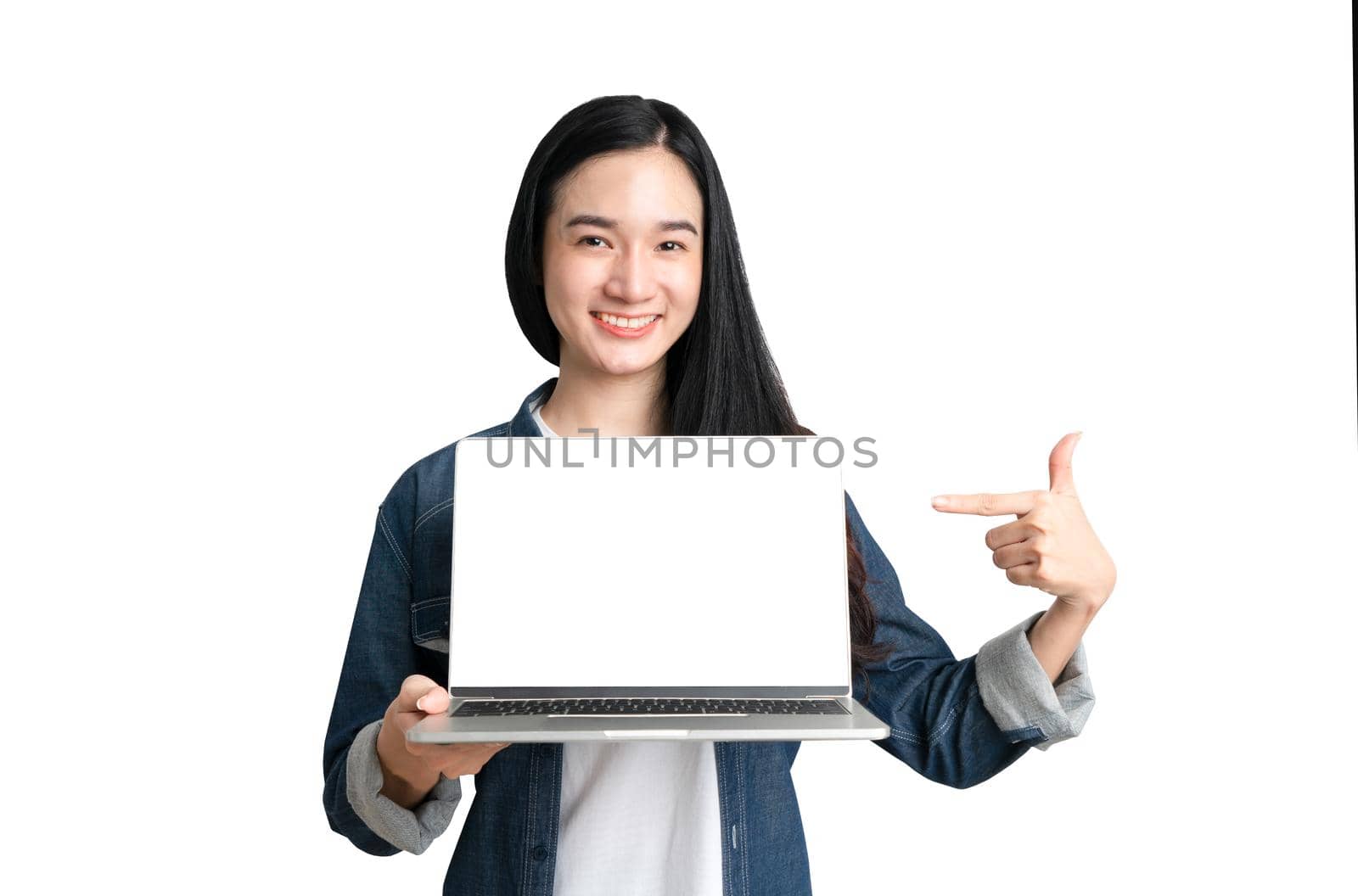 Beautiful woman holding laptop with mock up screen and present business concept by Buttus_casso