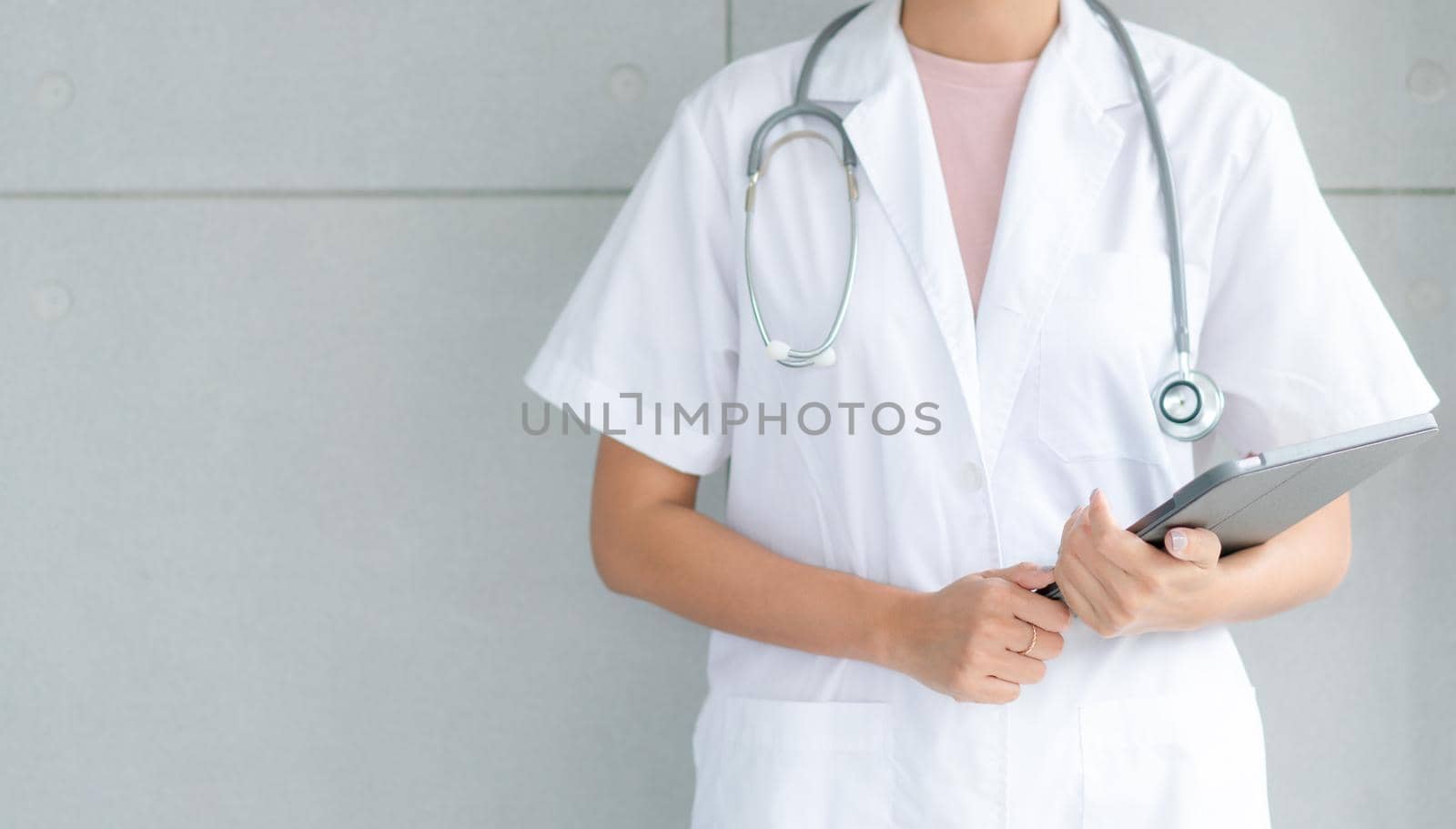 Telemedicine concept.  Hands doctor using tablet computer. Doctor online virtual consultation, chatting to patient, video call, virtual appointment on app.