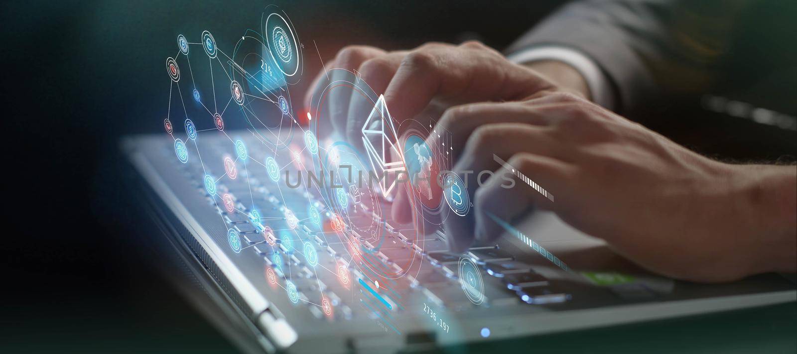 Blockchain and cryptocurrencies virtual infographics and close-up of male hands typing on laptop computer.