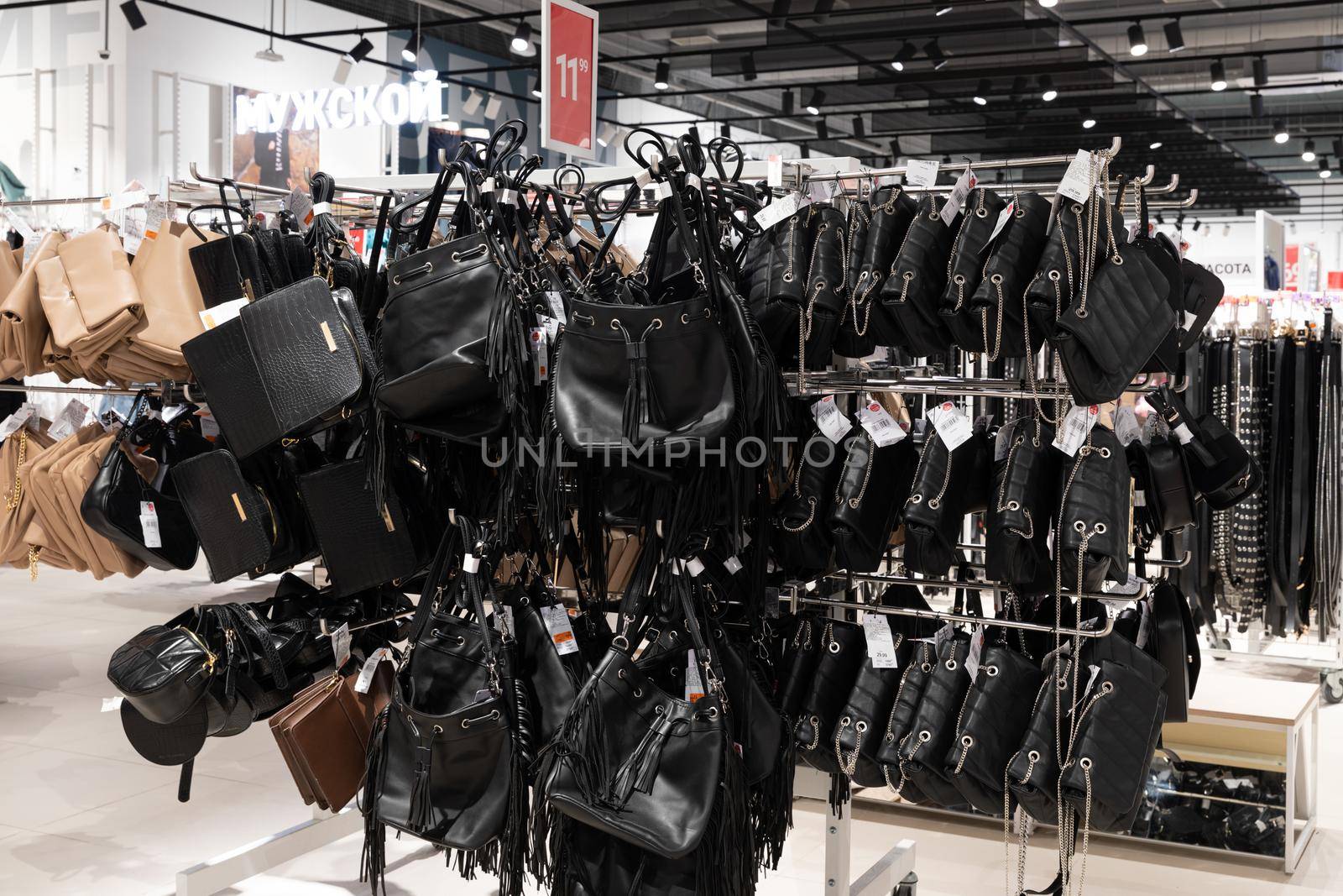 close-up of a showcase with women's leather bags in an accessories store.