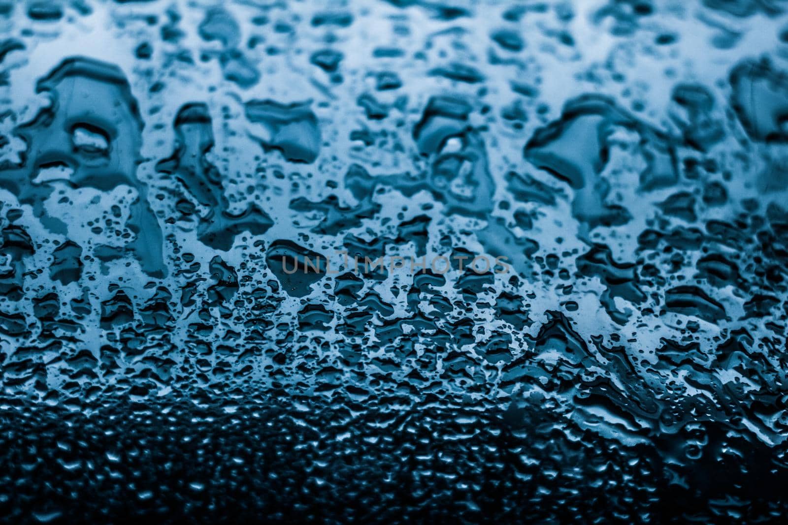 Liquid, wet and zen concept - Water texture abstract background, aqua drops on blue glass as science macro element, rainy weather and nature surface art backdrop for environmental brand design