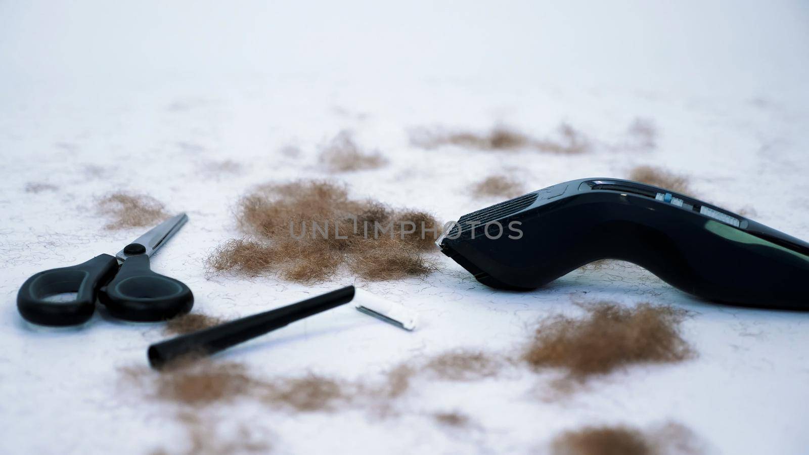close up of Barber tools and a lot of cut hair from the body, on white background. tools for depilation, hair removal, Men's haircut. clipper, electric razor, trimer, scissors. High quality photo