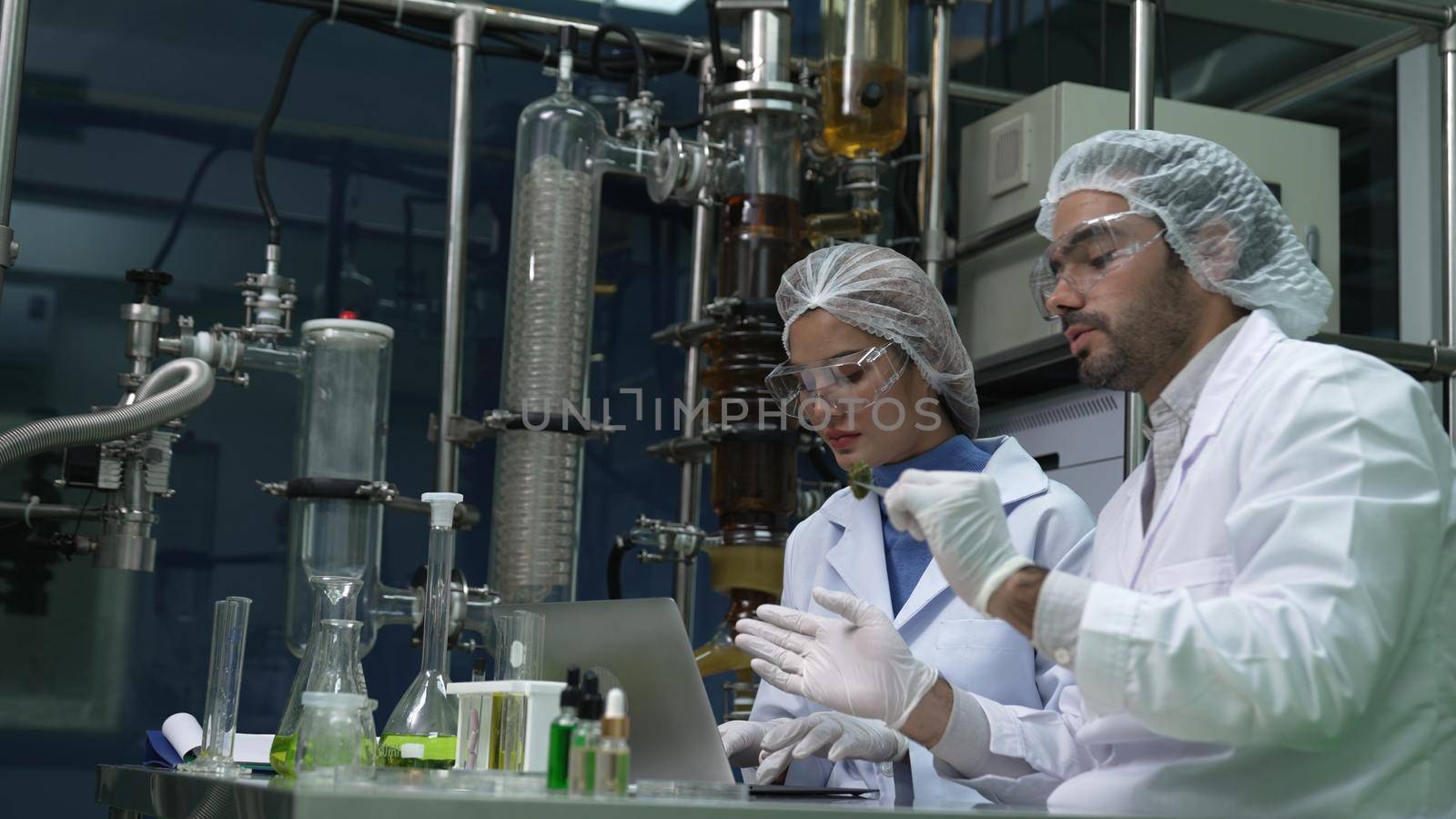 Two scientist in professional uniform working in laboratory for chemical and biomedical experiment