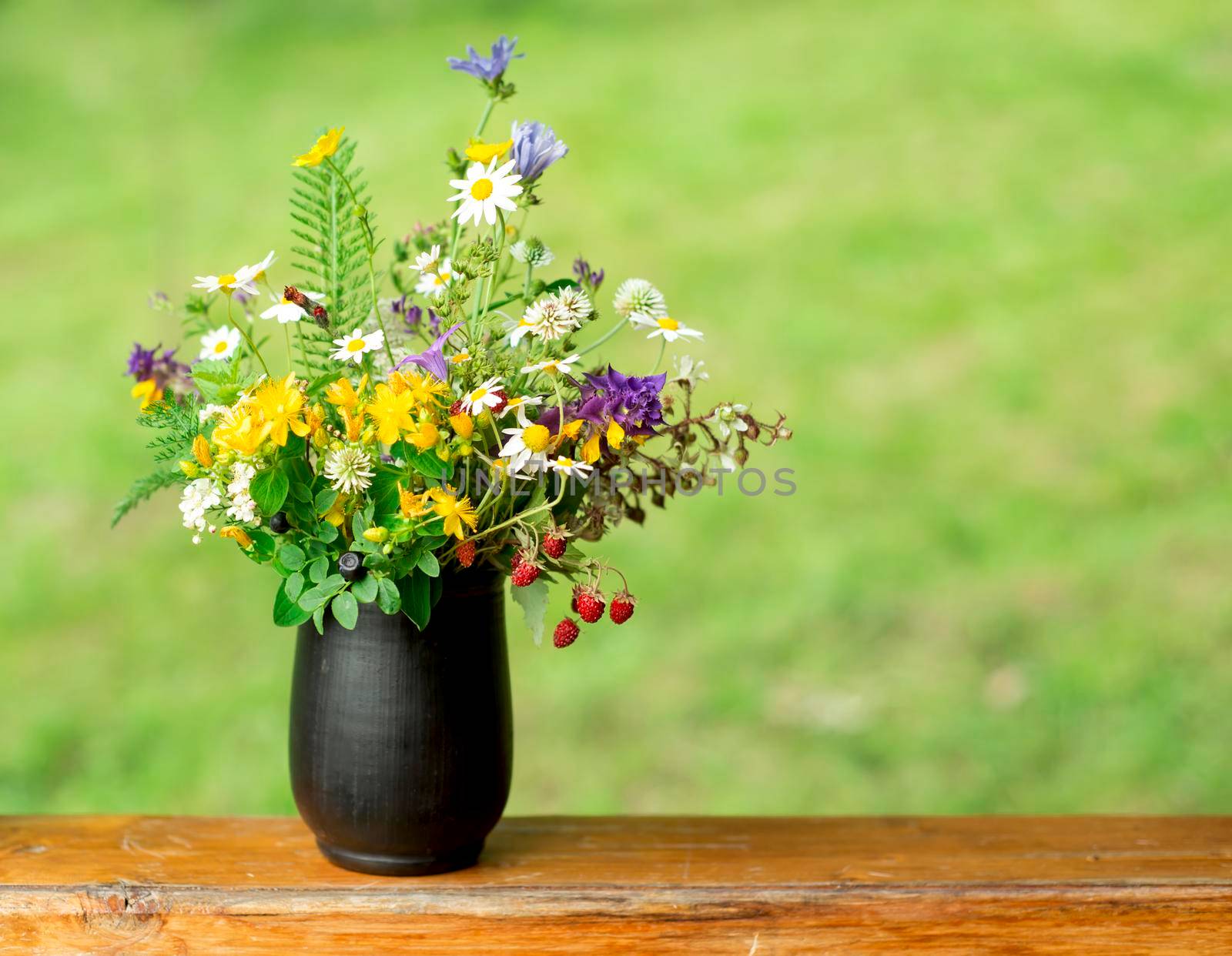 bouquet of wild flowers on a wooden background