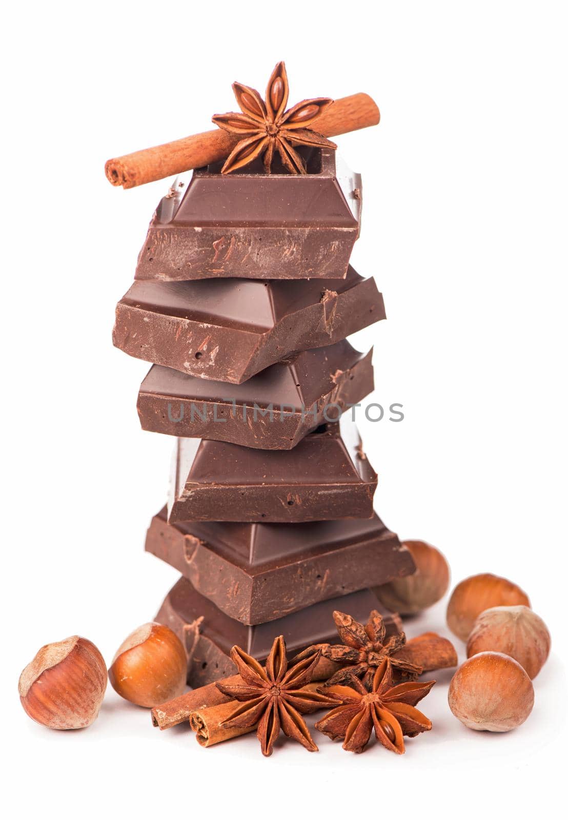 chocolate bars with nuts cinnamon anise and coffee on white background by aprilphoto