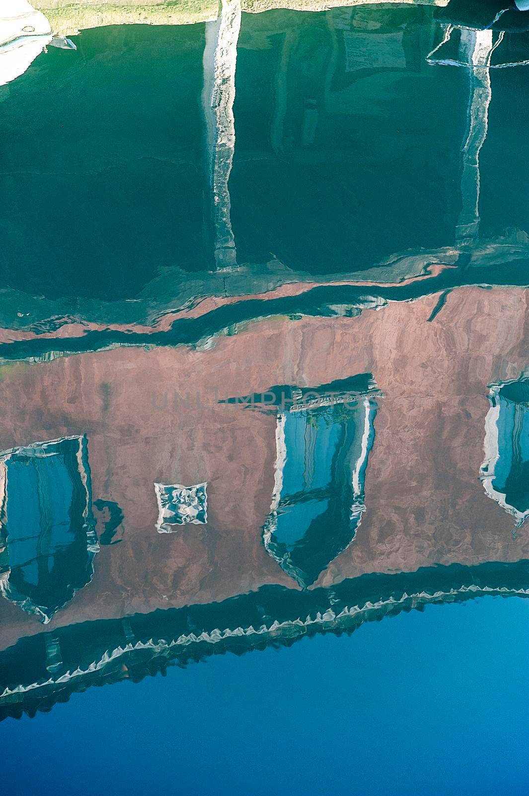 Buildings reflected on the water of one of the Murano canal