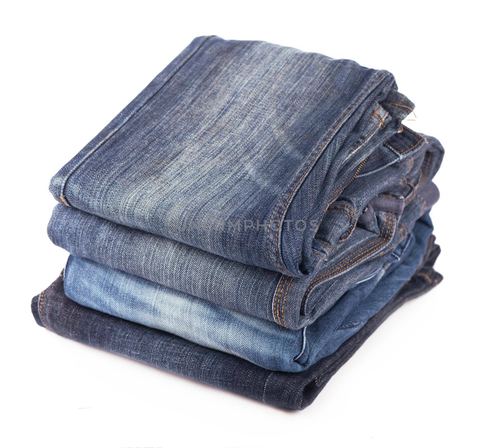 Stack of blue jeans on a white background by aprilphoto