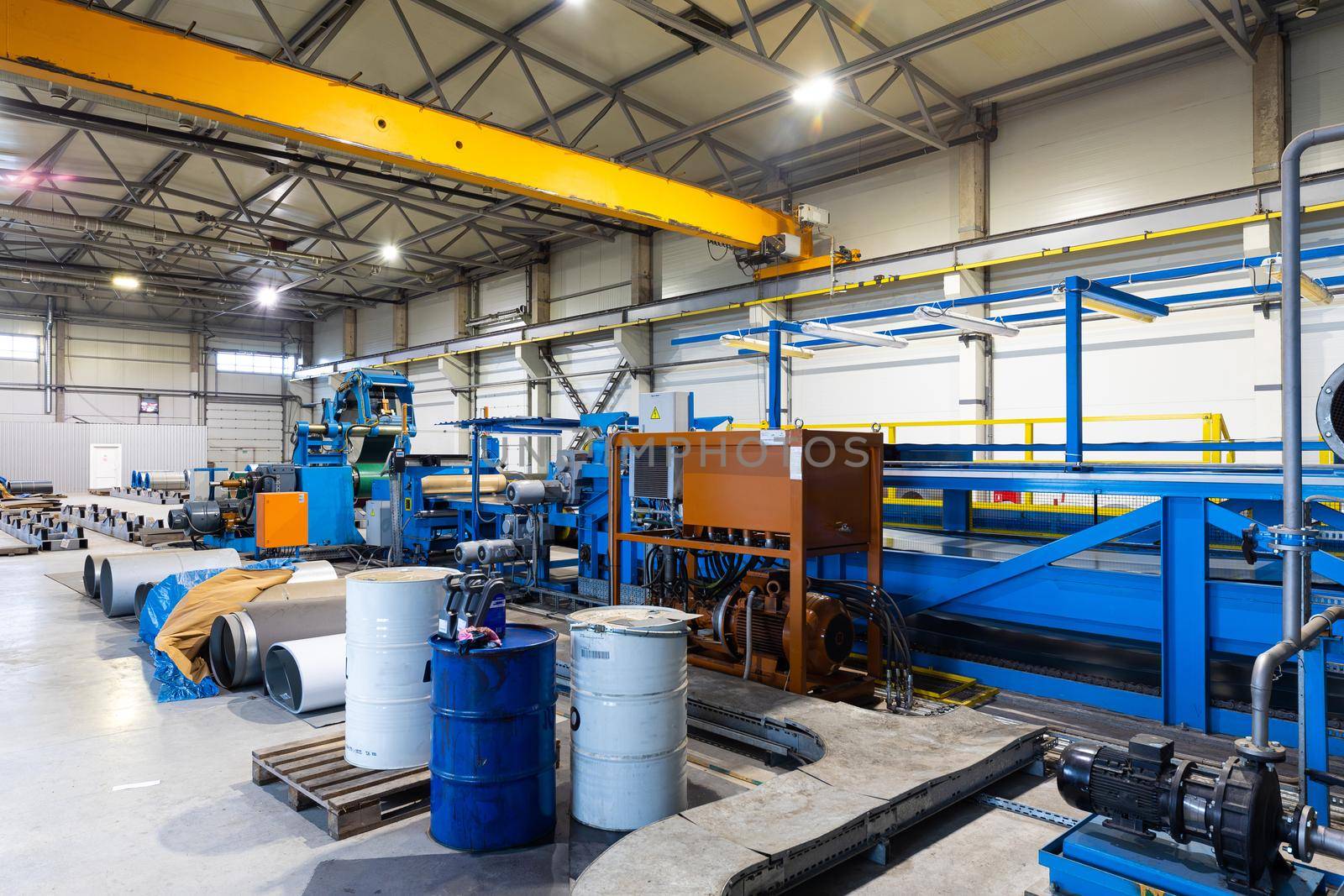 Photo shot of rolls of steel sheet stored in warehouse; Cold rolled steel coils at the factory. Engineering production.