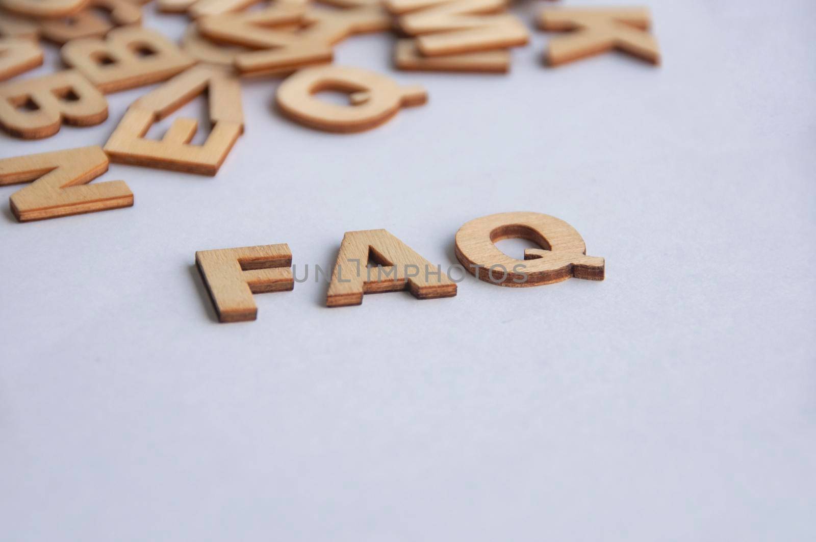 FAQ text on white background. Question and answer concept.