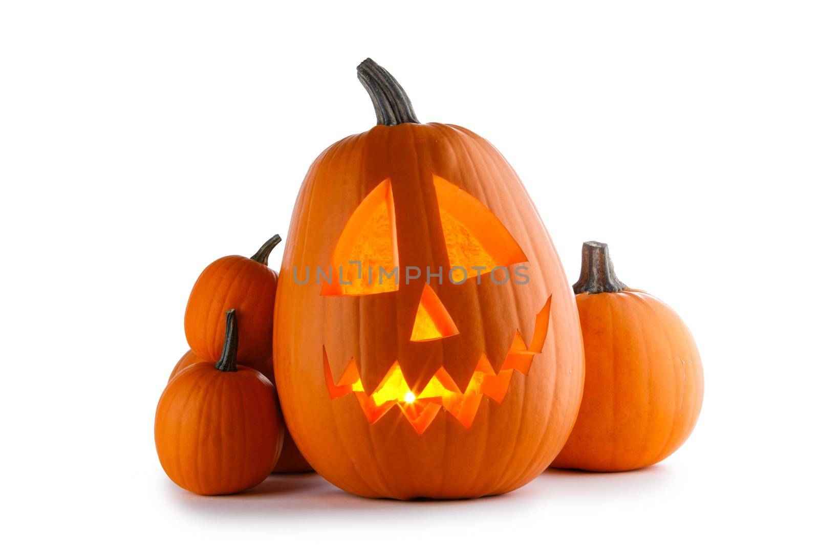 Halloween pumpkins isolated on white background, carved pumpkin with burning candle inside