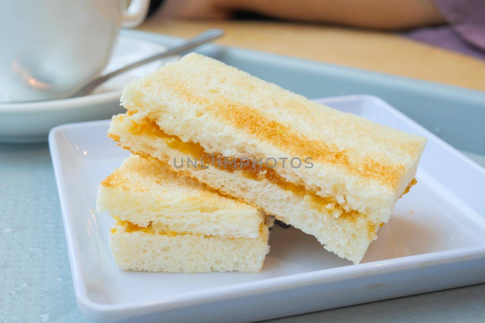 kaya toast with a cup of tea on table by towfiq007