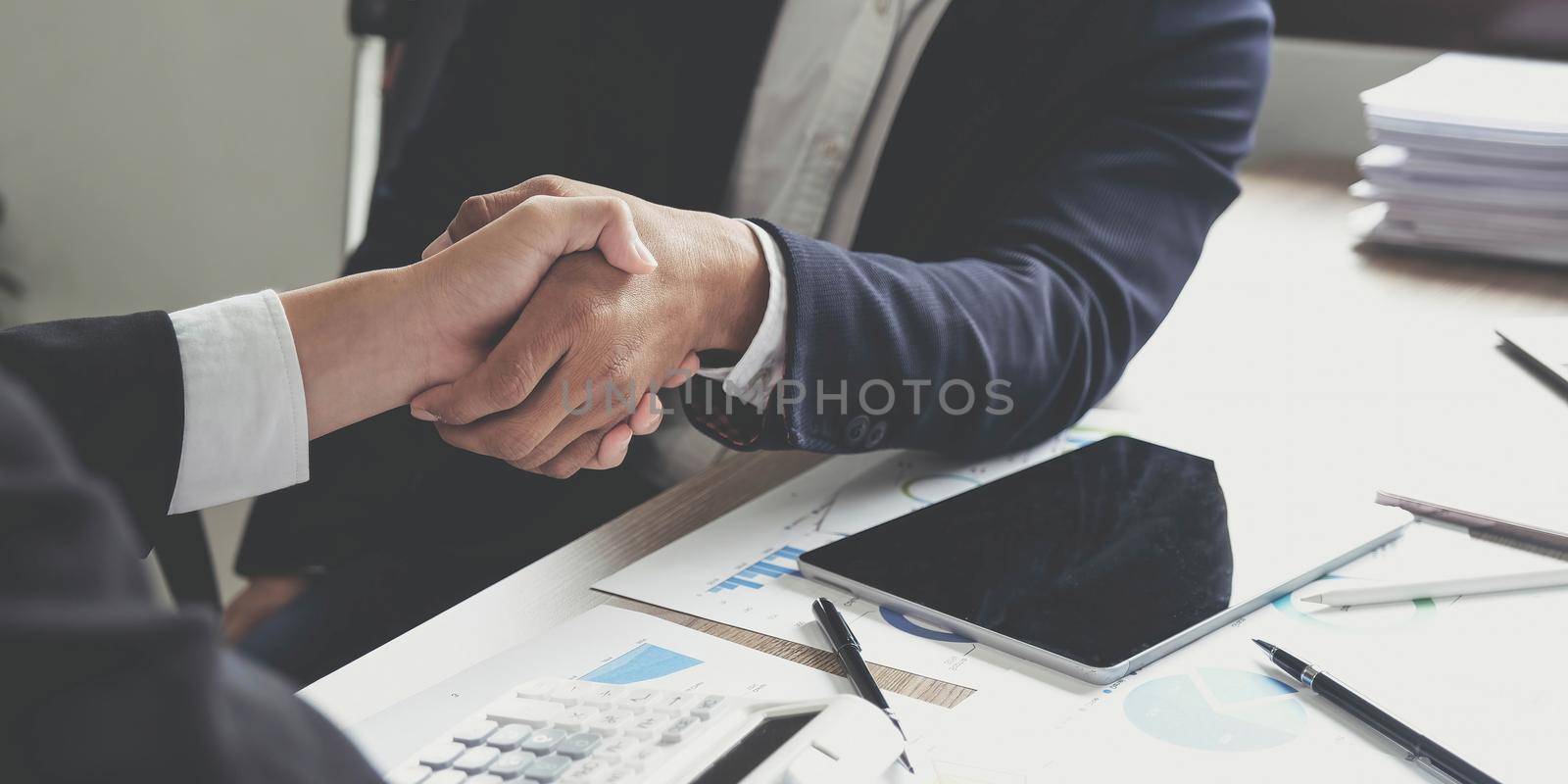 Business people shaking hands, finishing up meeting, business etiquette, congratulation, merger and acquisition concept.