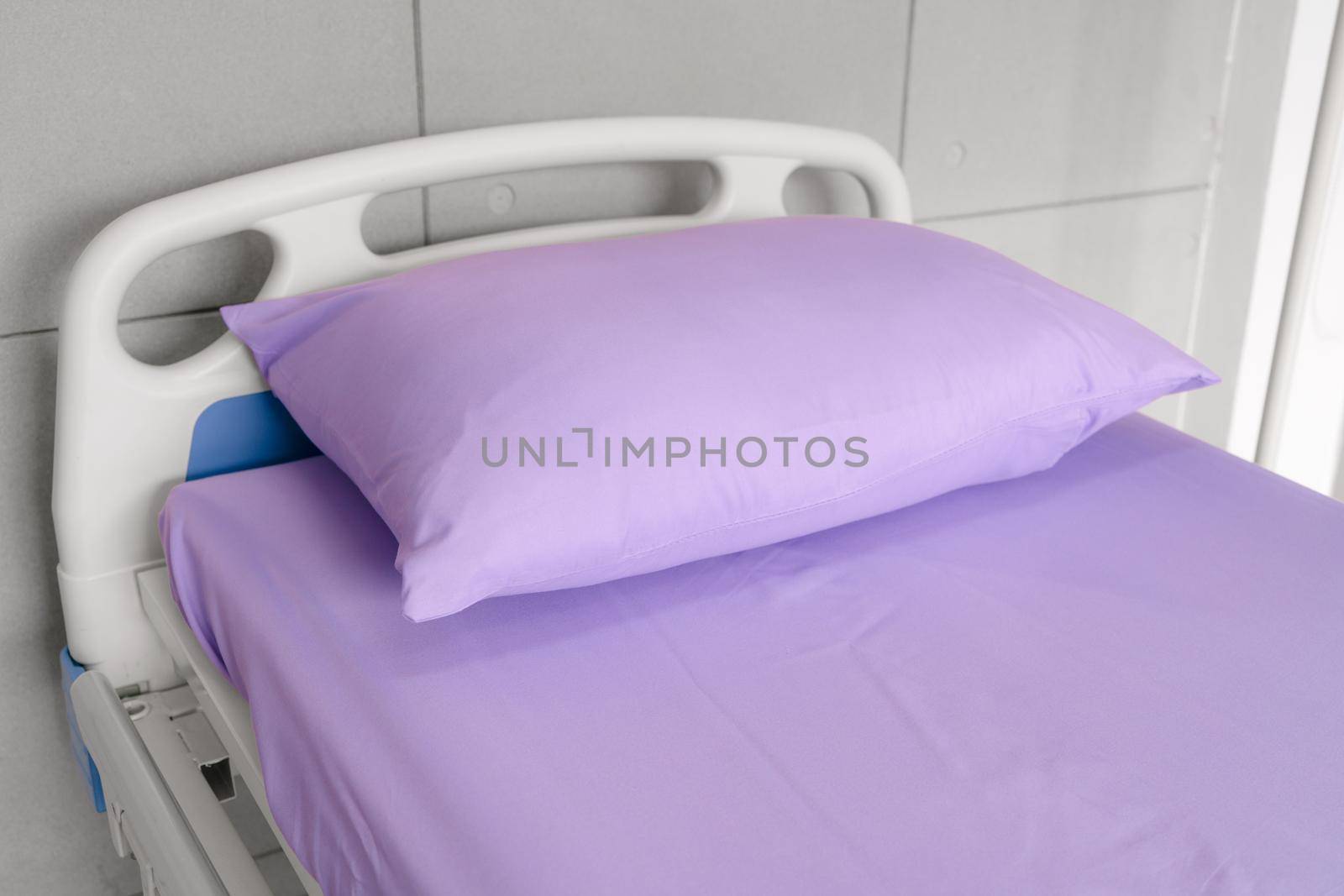 Empty patient bed in hospital room. Bed is for patient admitted to hospital for medical treatment by Buttus_casso