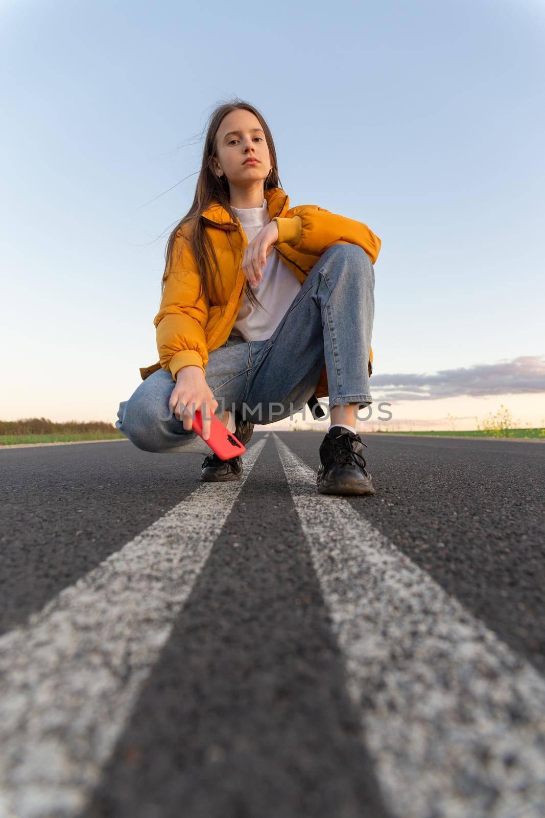 Cool modern teen girl poses on a lonely road by BY-_-BY
