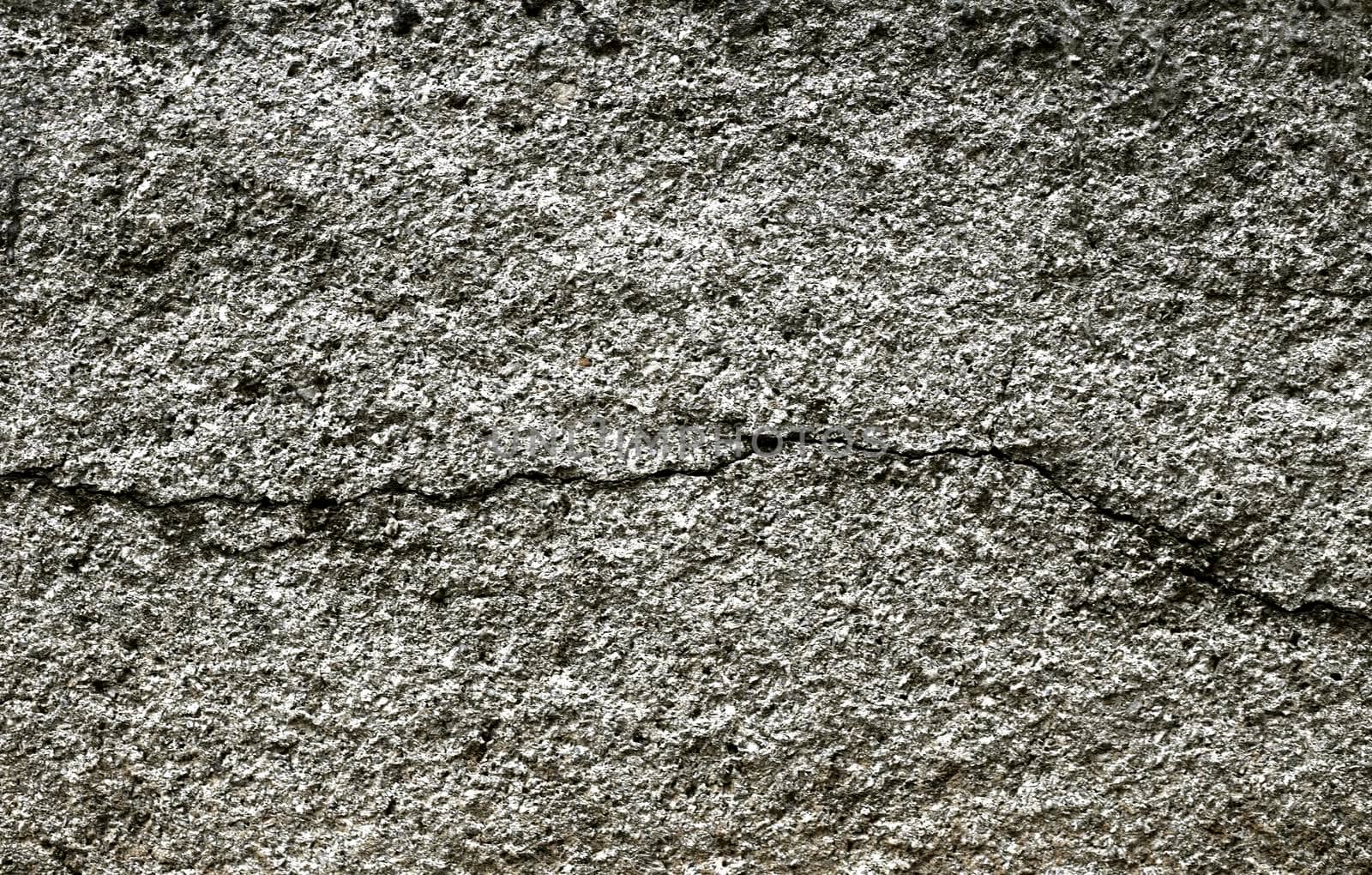 Old gray cracked stucco on the wall.