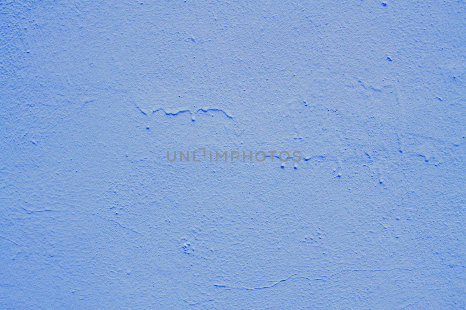 Blue abstract background. Beautiful blue textured plaster on the wall. Background from blue stucco..