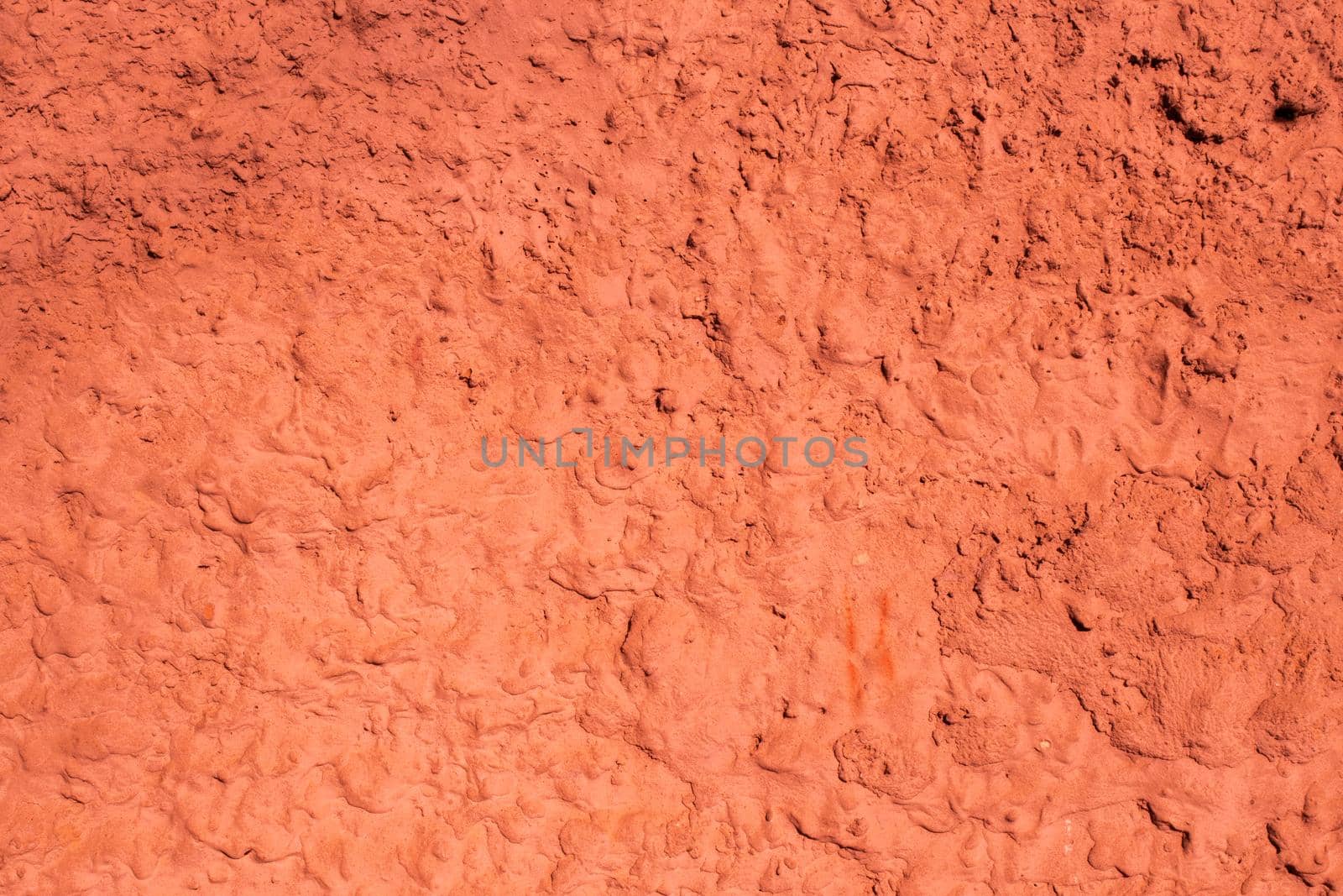 Old peeling paint on the wall..Red abstract background..Beautiful red textured stucco on the wall..Background from red stucco.