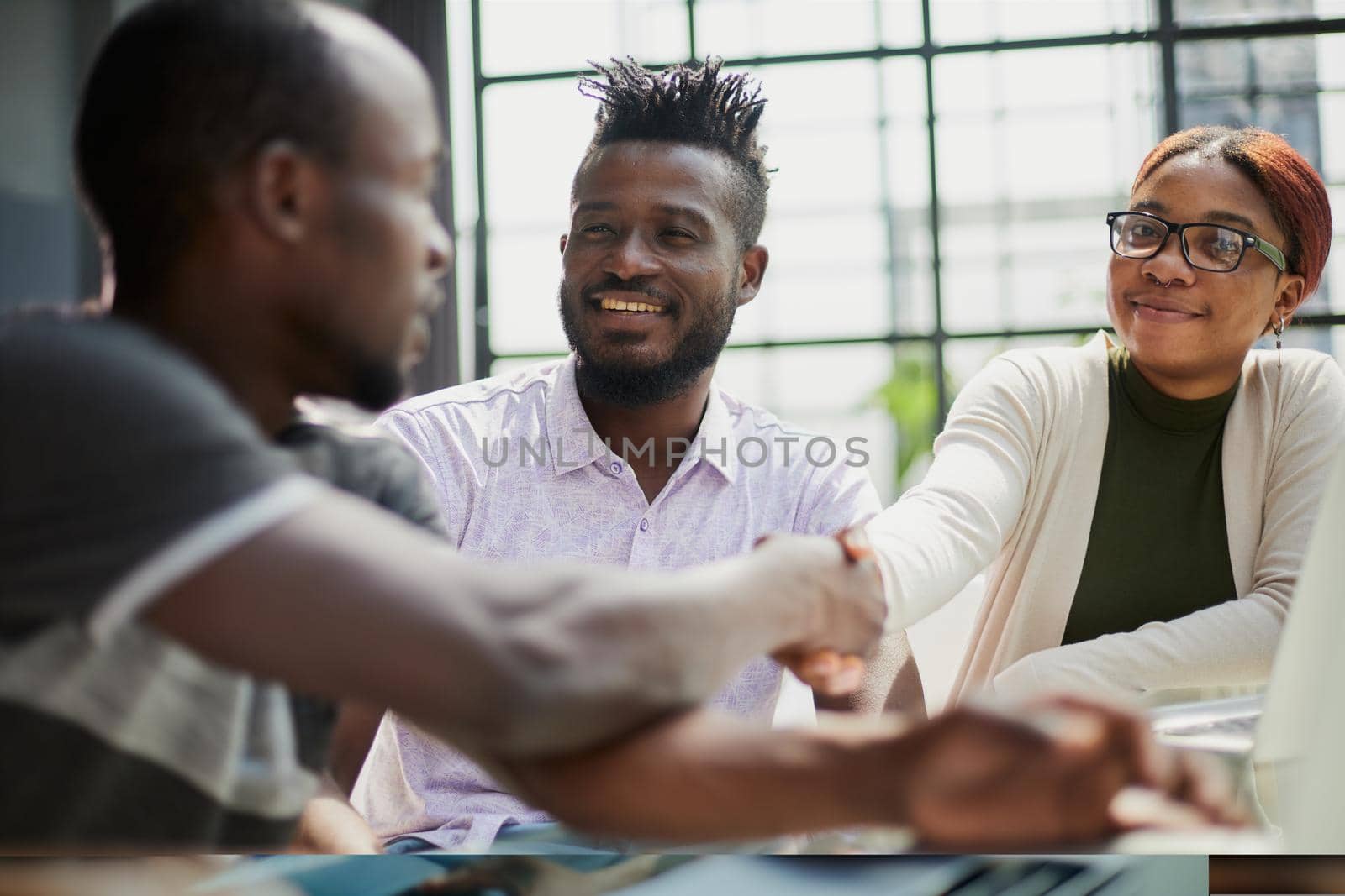 business people handshaking at modern light office by Prosto