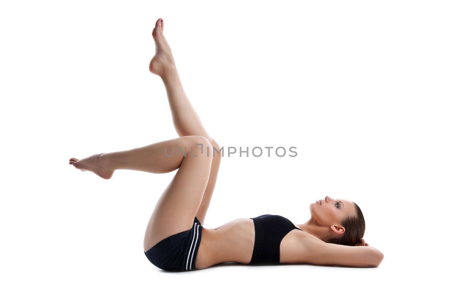 Beauty young woman lay on white in fitness dress isolated on white