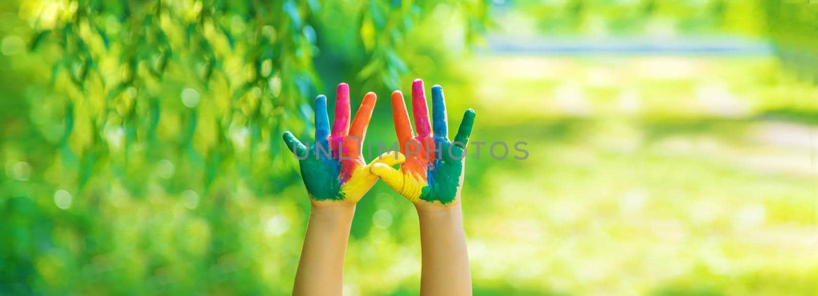 child with painted hands and legs. Selective focus. by yanadjana
