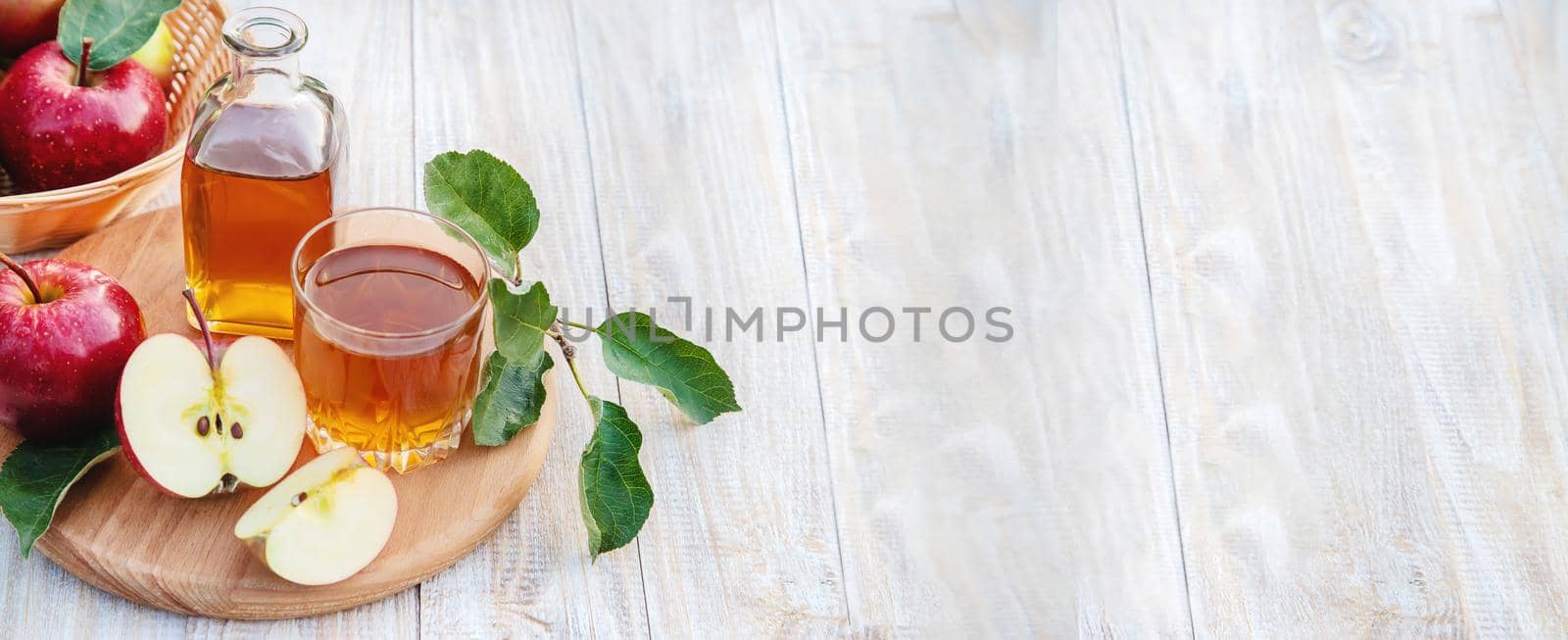 Apple juice in a glass. Selective focus. by yanadjana