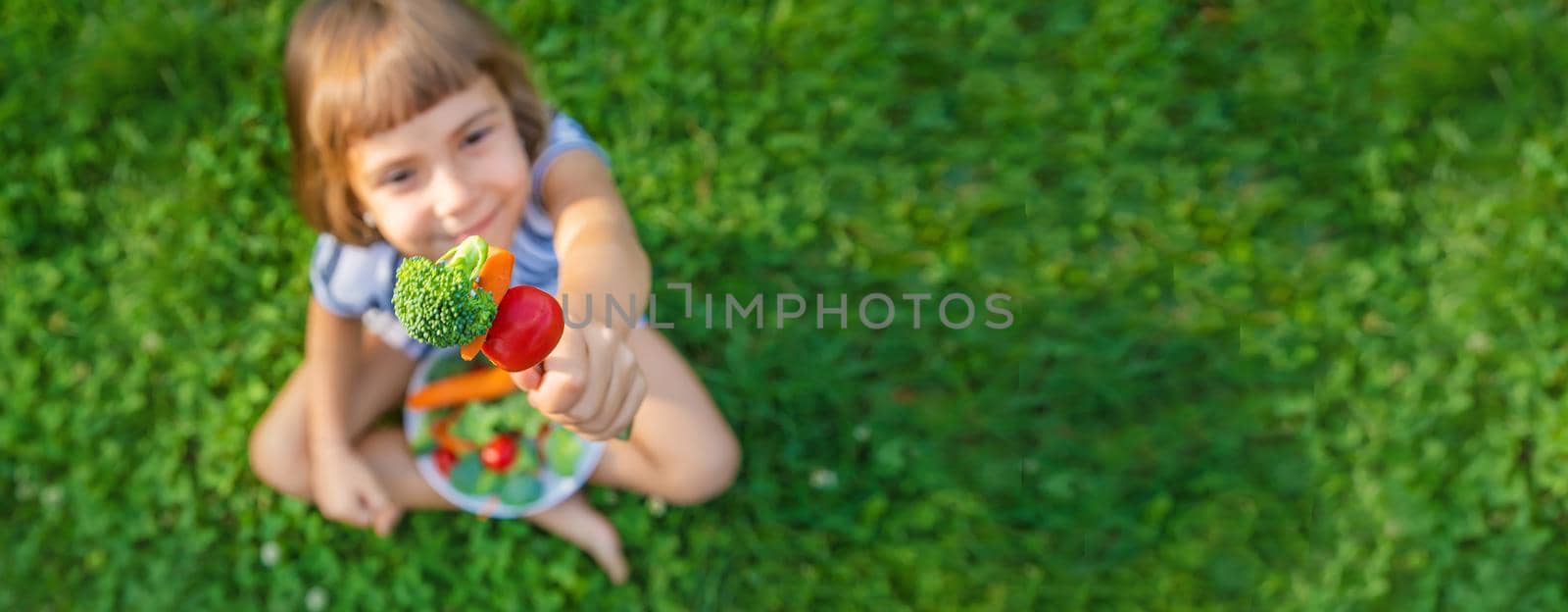 child eats vegetables broccoli and carrots. Selective focus.