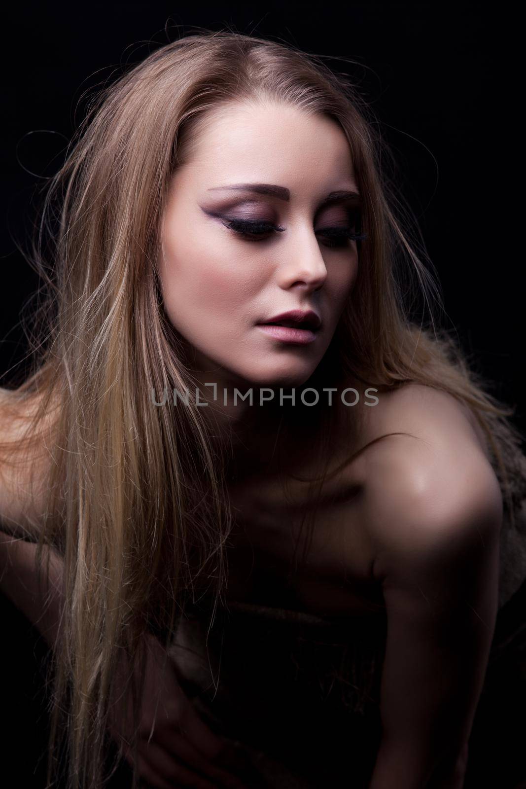 Studio portrait of beautiful blonde young woman