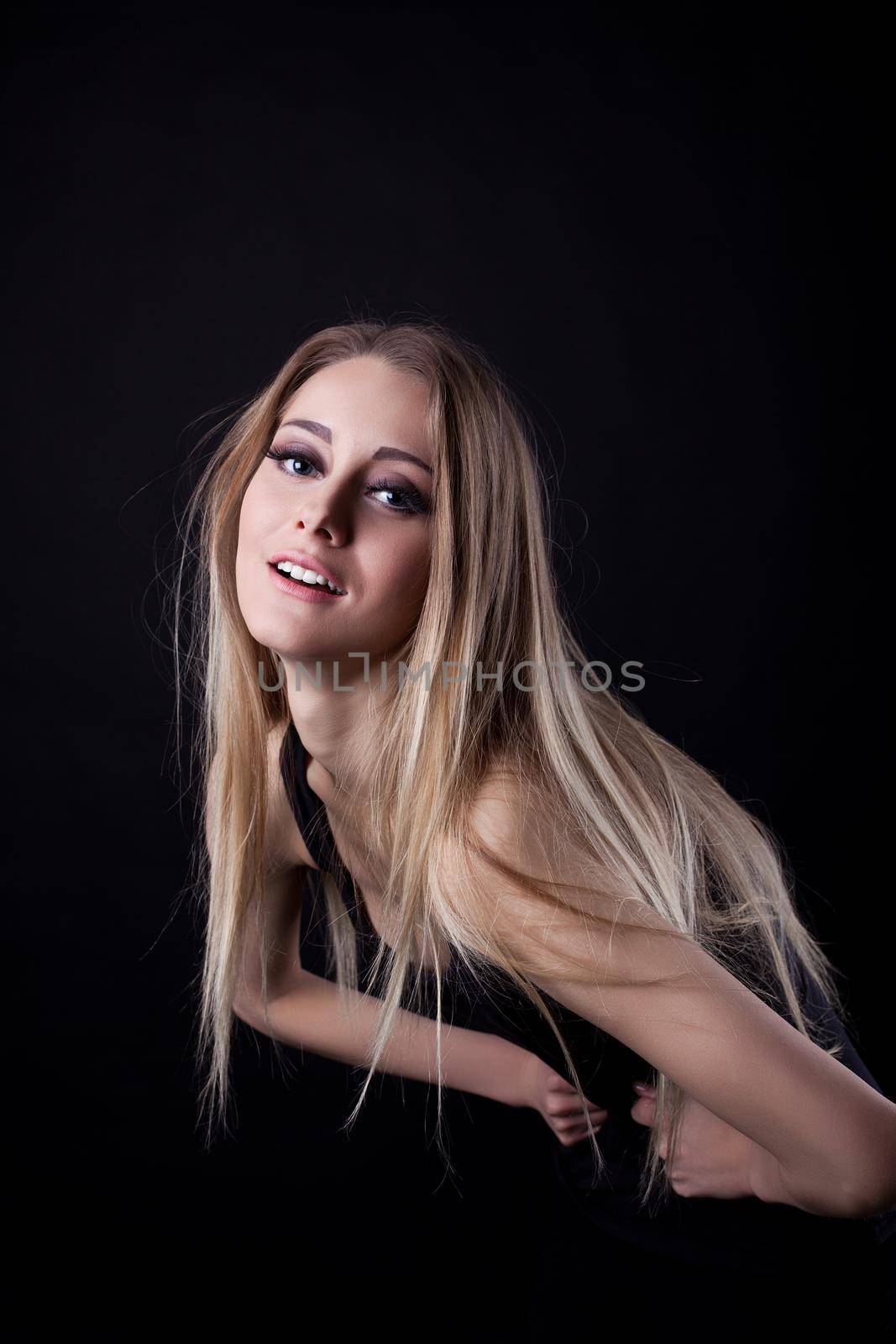 Portrait of blonde woman. Isolated on black