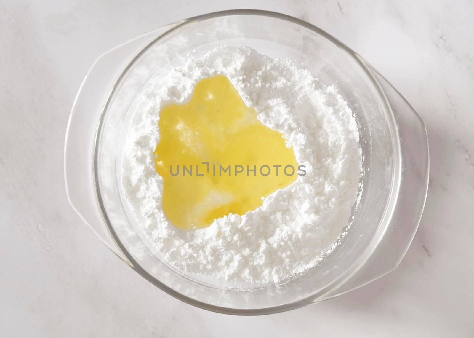 step of Cooking icing for cookies, powdered sugar with whites in a bowl, homemade holiday baked good. High quality photo