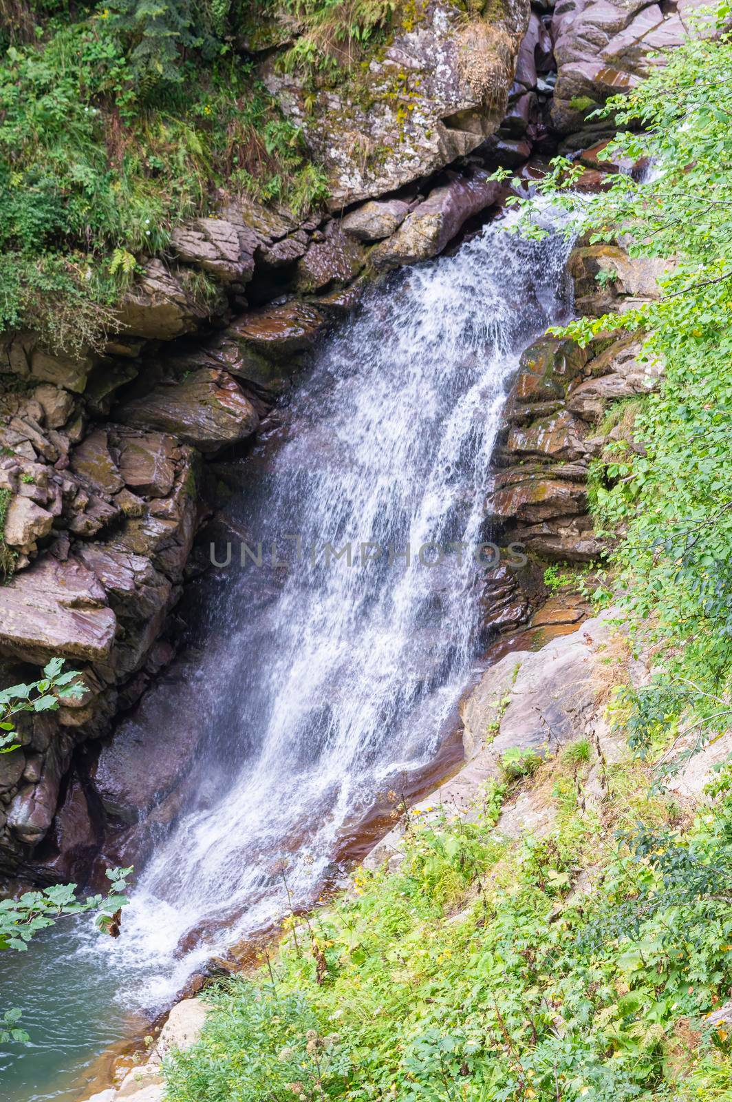 waterfall in the mountains of the mountain river by roman112007