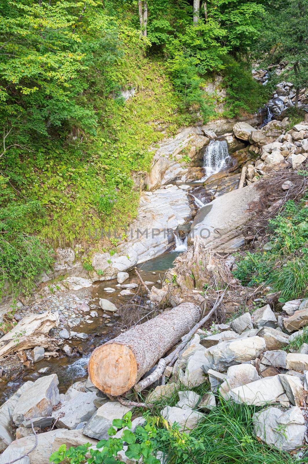 waterfall in the mountains of the mountain river. sochi rosa khutor mendelikha waterfalls park. photo