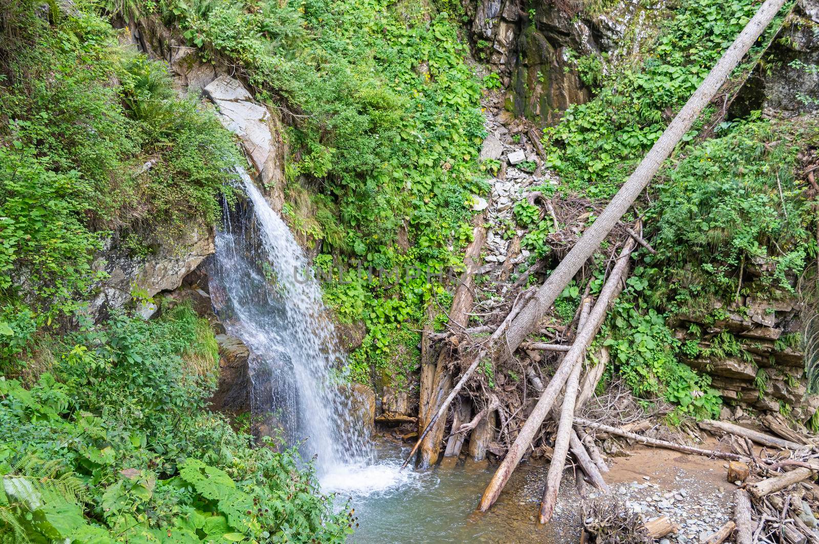 waterfall in the mountains of the mountain river. sochi rosa khutor mendelikha waterfalls park. photo