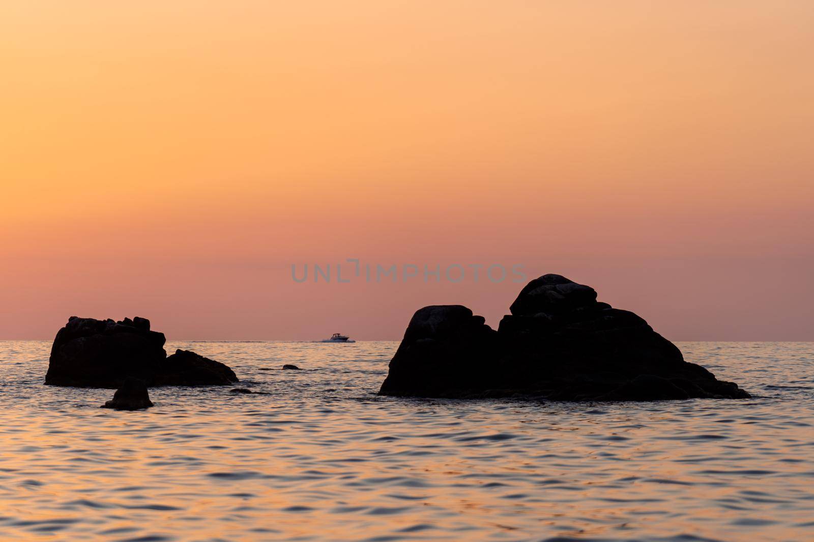 Beautiful view of orange sunset seascape with rocks in Italy. Colorful sunrise landscape by photolime