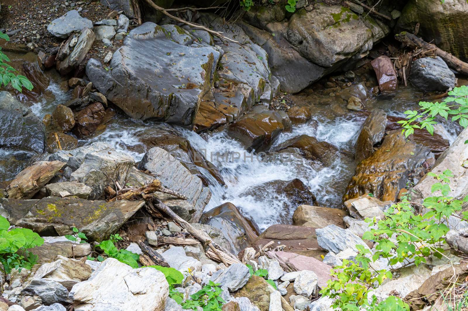 waterfall in the mountains of the mountain river. sochi rosa khutor mendelikha waterfalls park. photo