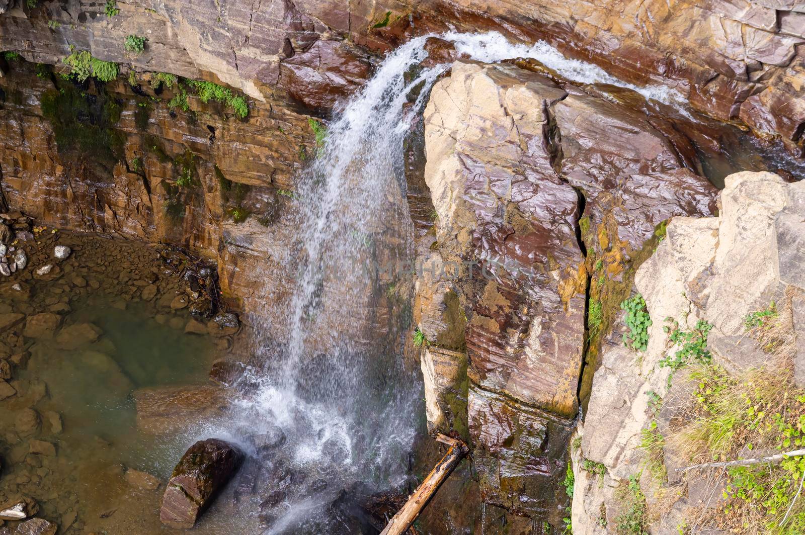 waterfall in the mountains of the mountain river. sochi rosa khutor mendelikha waterfalls park. photo