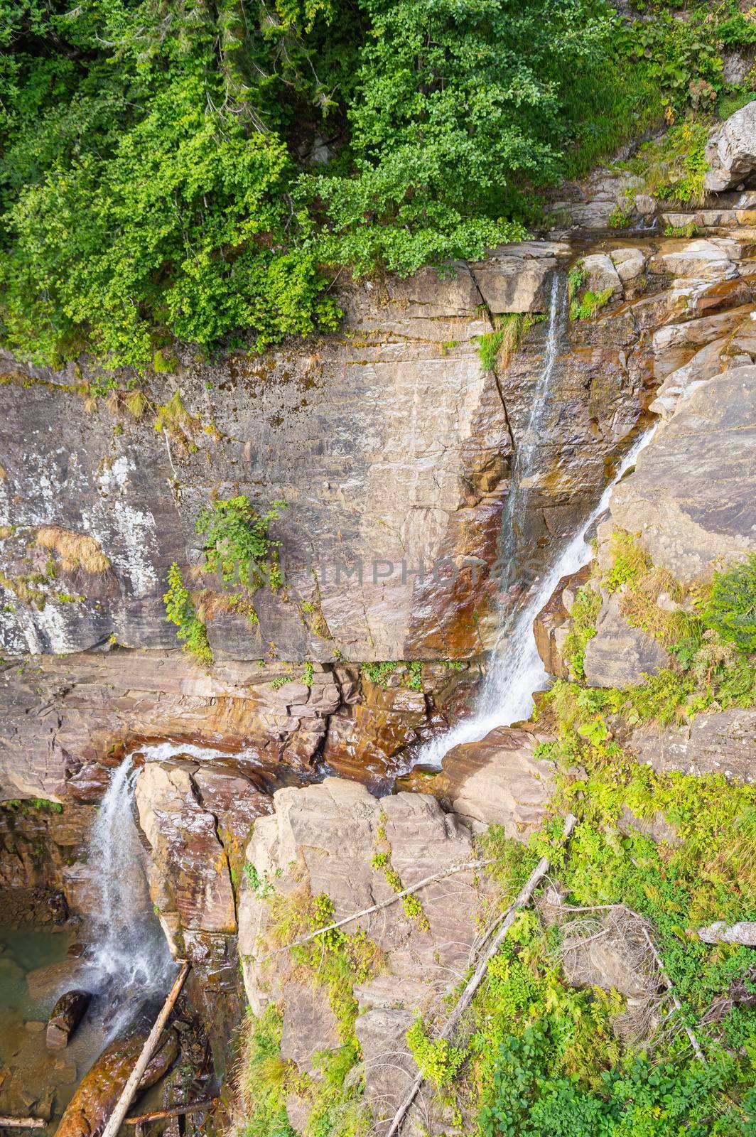 waterfall in the mountains of the mountain river. sochi rosa khutor mendelikha waterfalls park. photo