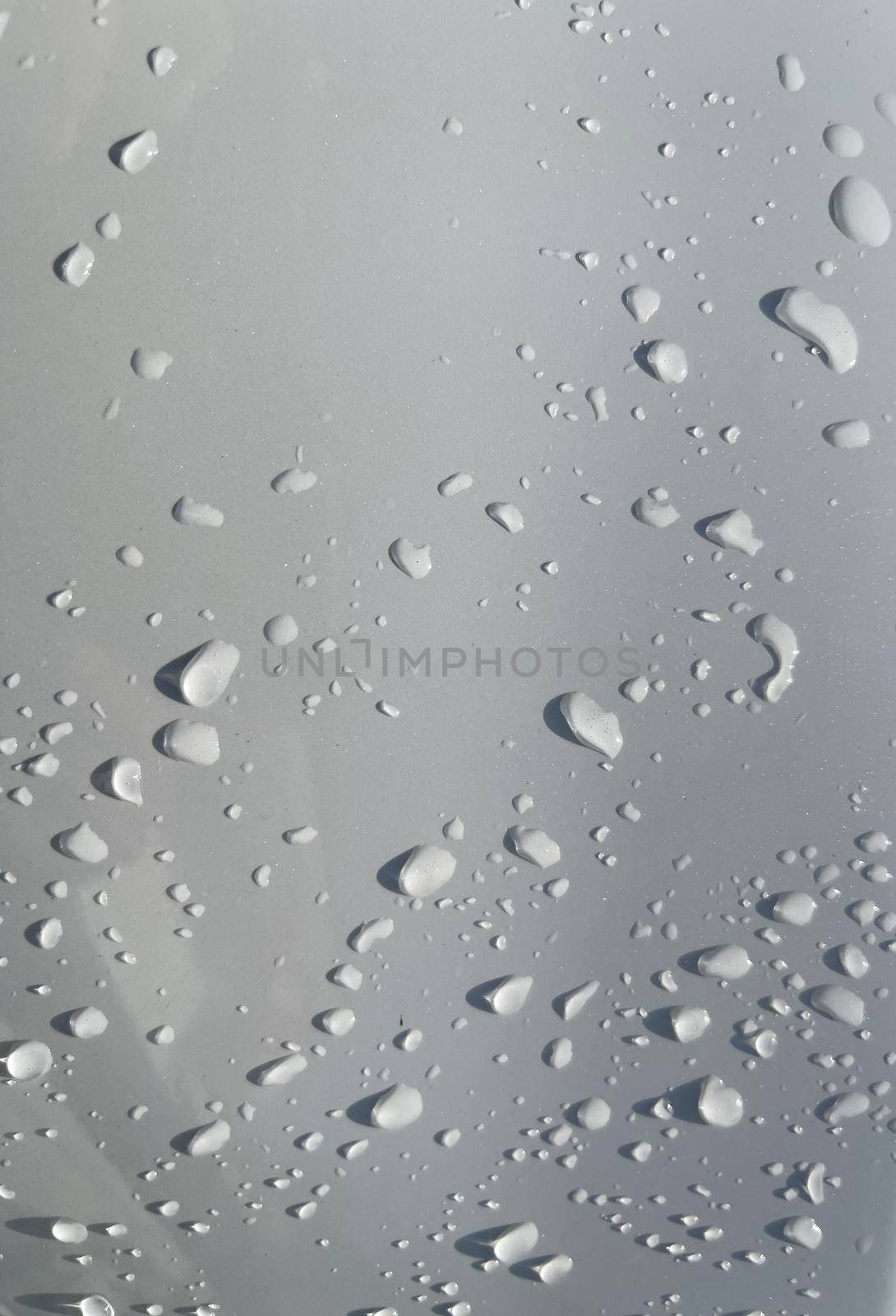 Water droplets perspective through white color surface good for multimedia content backgrounds, fresh dew