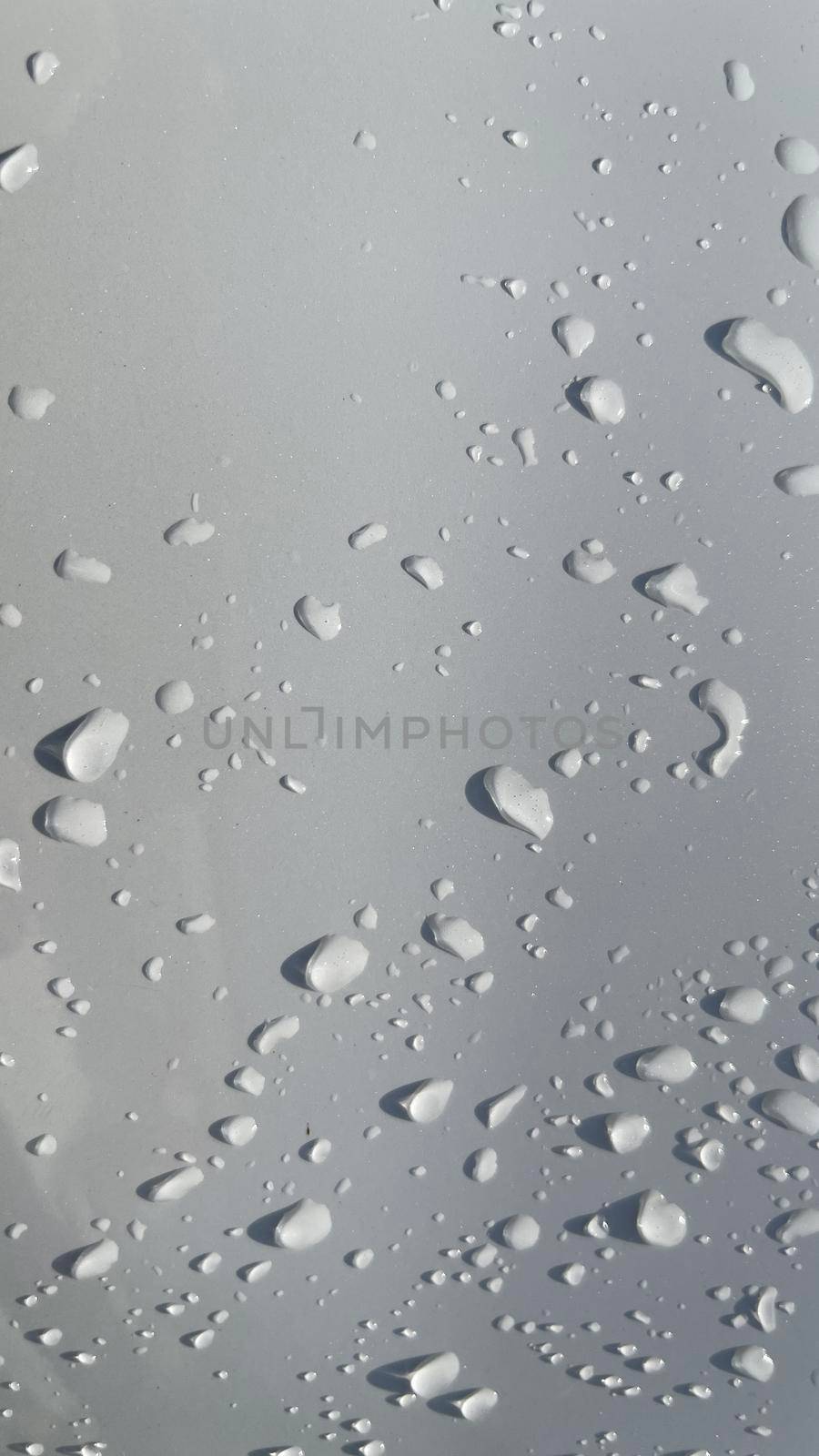 Water droplets perspective through white color surface good for multimedia content backgrounds, fresh dew