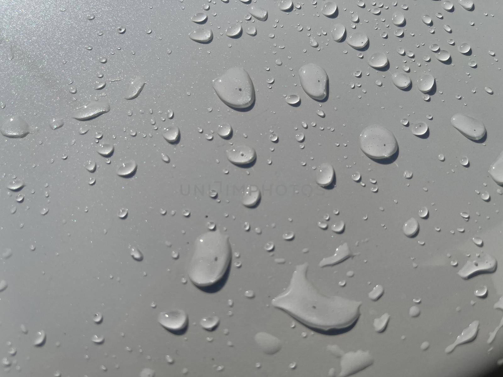 Water droplets perspective through white color surface good for multimedia content backgrounds, fresh dew