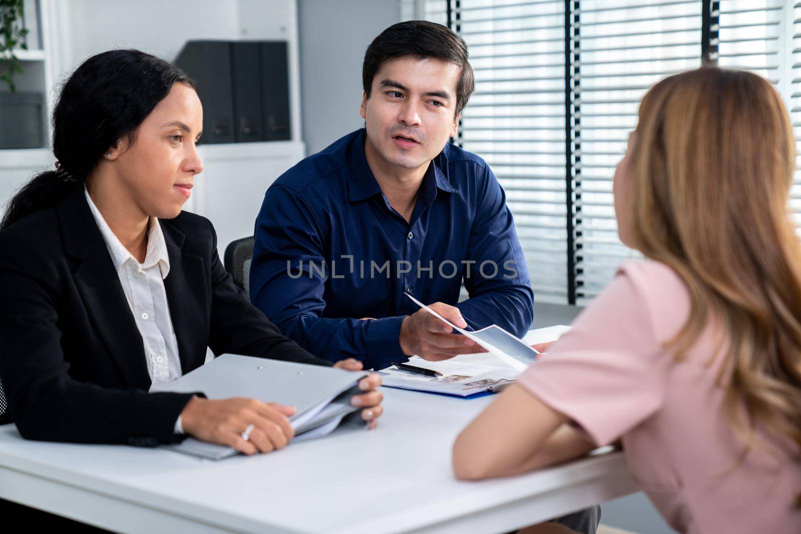 A young female asian candidate tries to impress her interviewer by being competent. International company, multicultural environment in workplace.