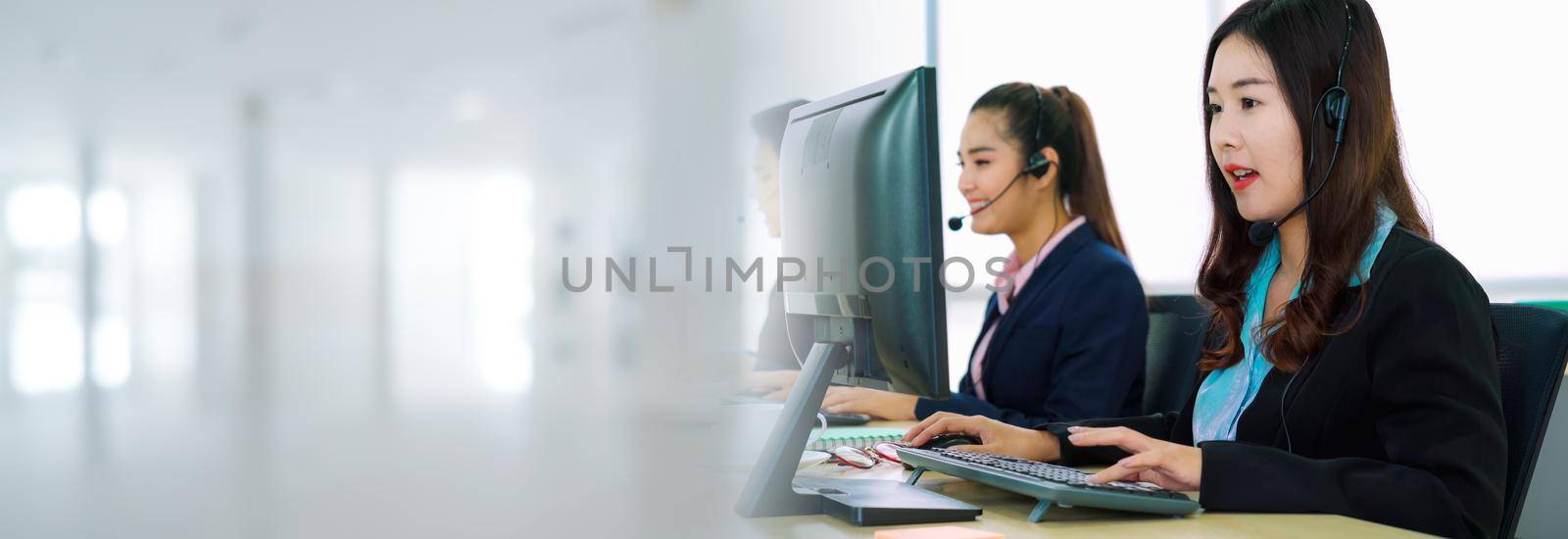 Business people wearing headset working in office in widen view to support remote customer or colleague. Call center, telemarketing, customer support agent provide service on telephone video call.