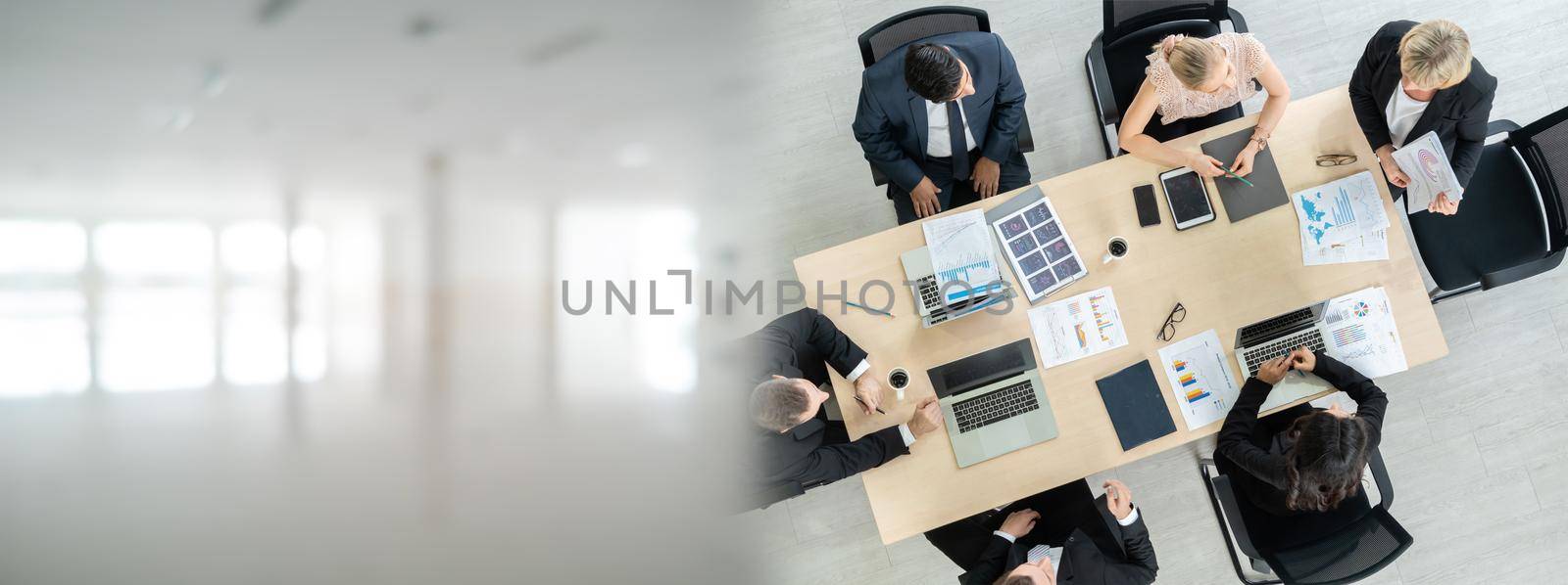 Business people group meeting shot from top widen view in office . Profession businesswomen, businessmen and office workers working in team conference with project planning document on meeting table .