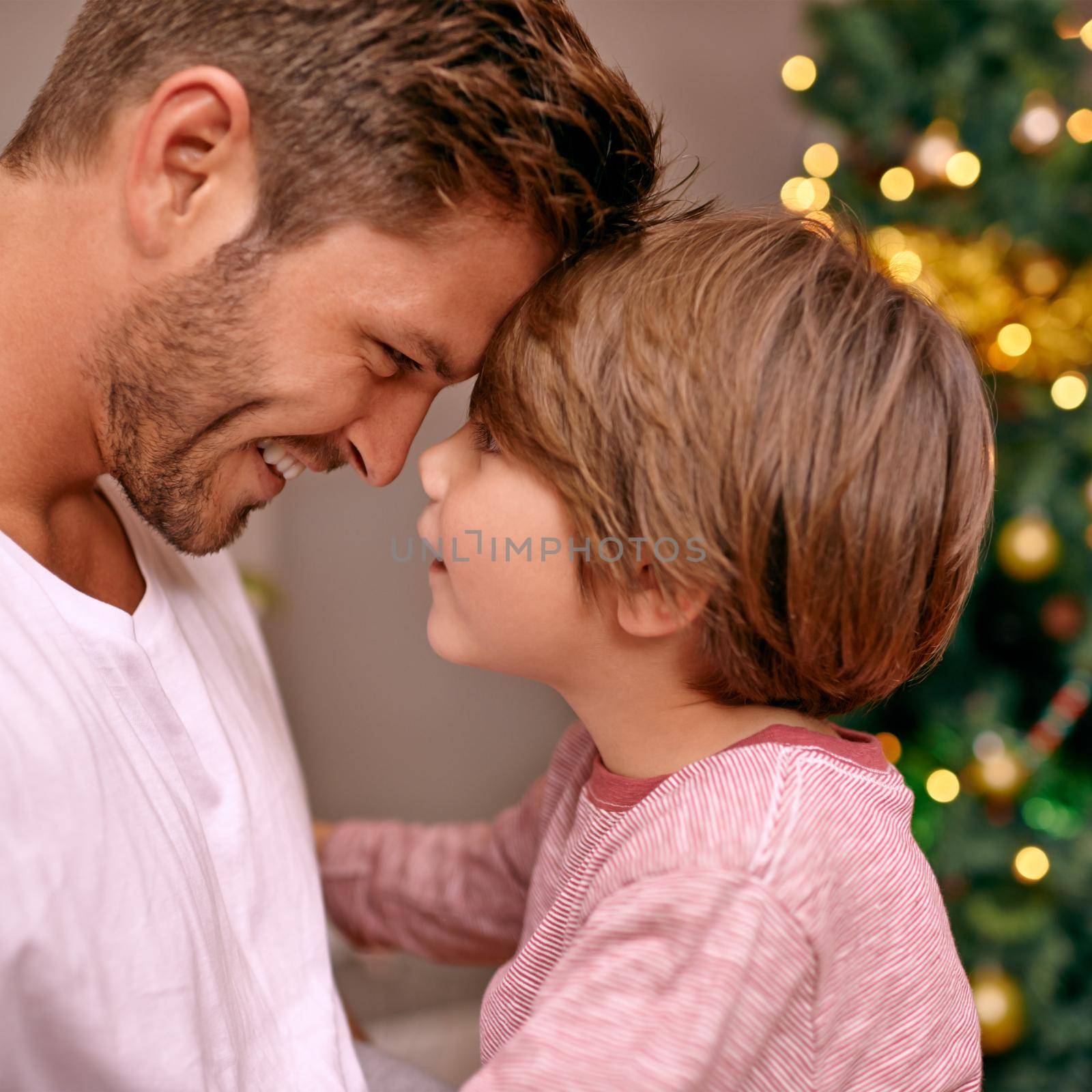 Its a family tradition...A young father and his son on Christmas ece. by YuriArcurs