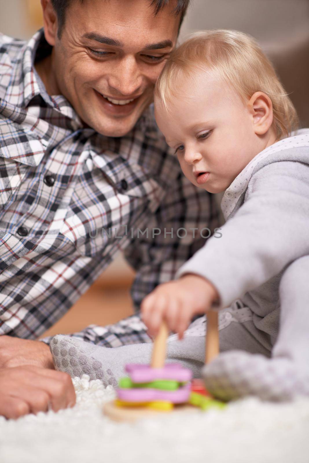 Spwnding time with my little princess. A single father sitting with his baby girl as she plays with blocks