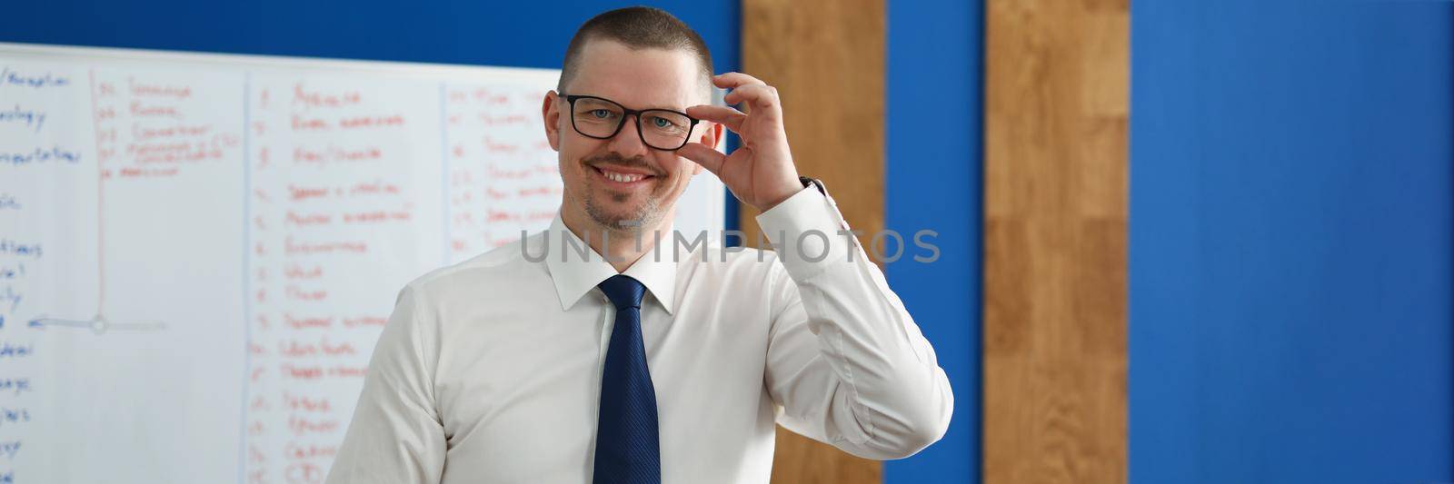 Happy male business coach in the office, close-up by kuprevich