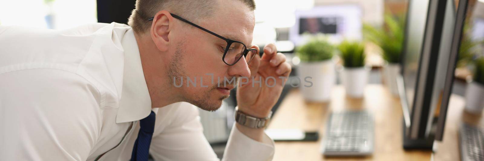 A man in the office is editing a report with a diagram, close-up, blurry. Changes in the financial statement of the company