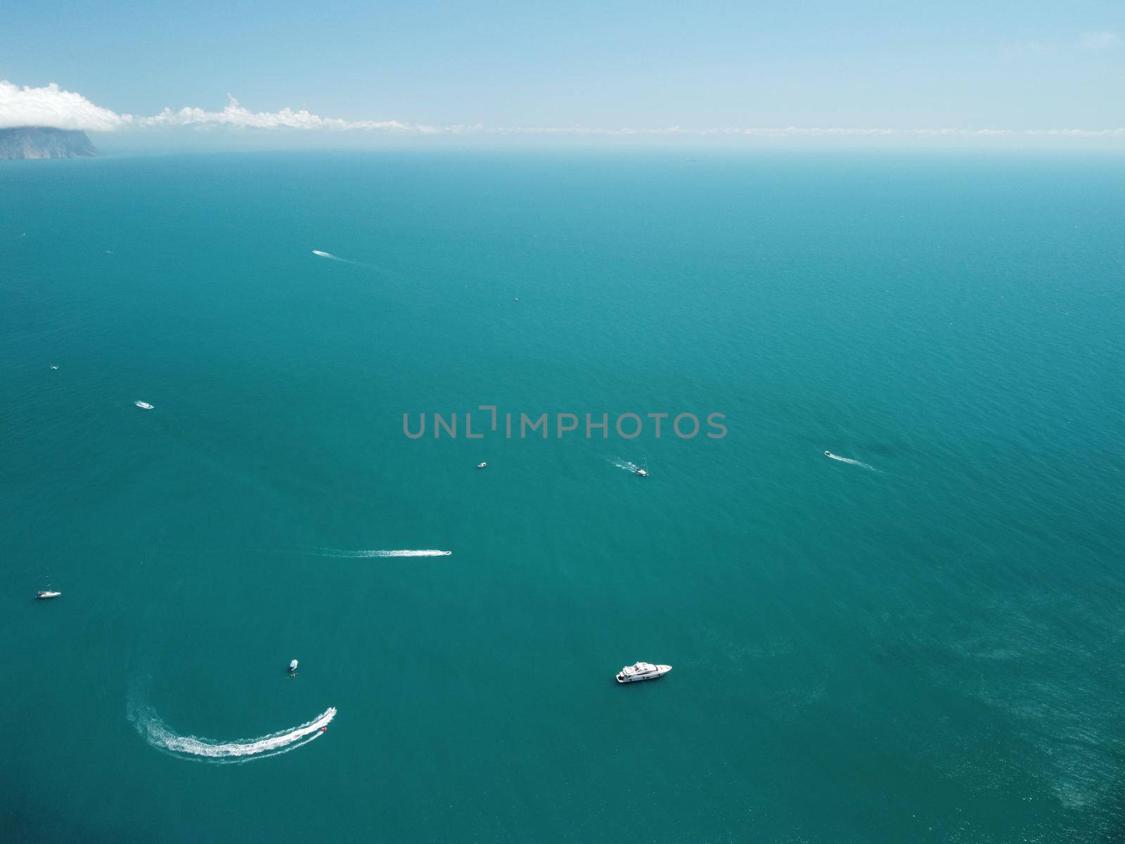 Aerial boat race. Luxury cruise trip. View from above of white boat on deep blue water. Aerial view of rich yacht sailing sea. Motor boat racing wave. Summer journey on luxury ship