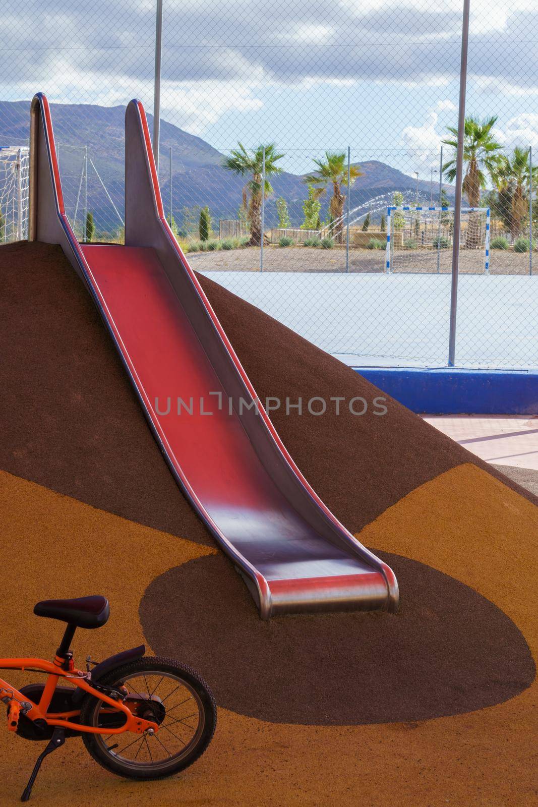 slide and bicycle in a playground, playground equipment for children