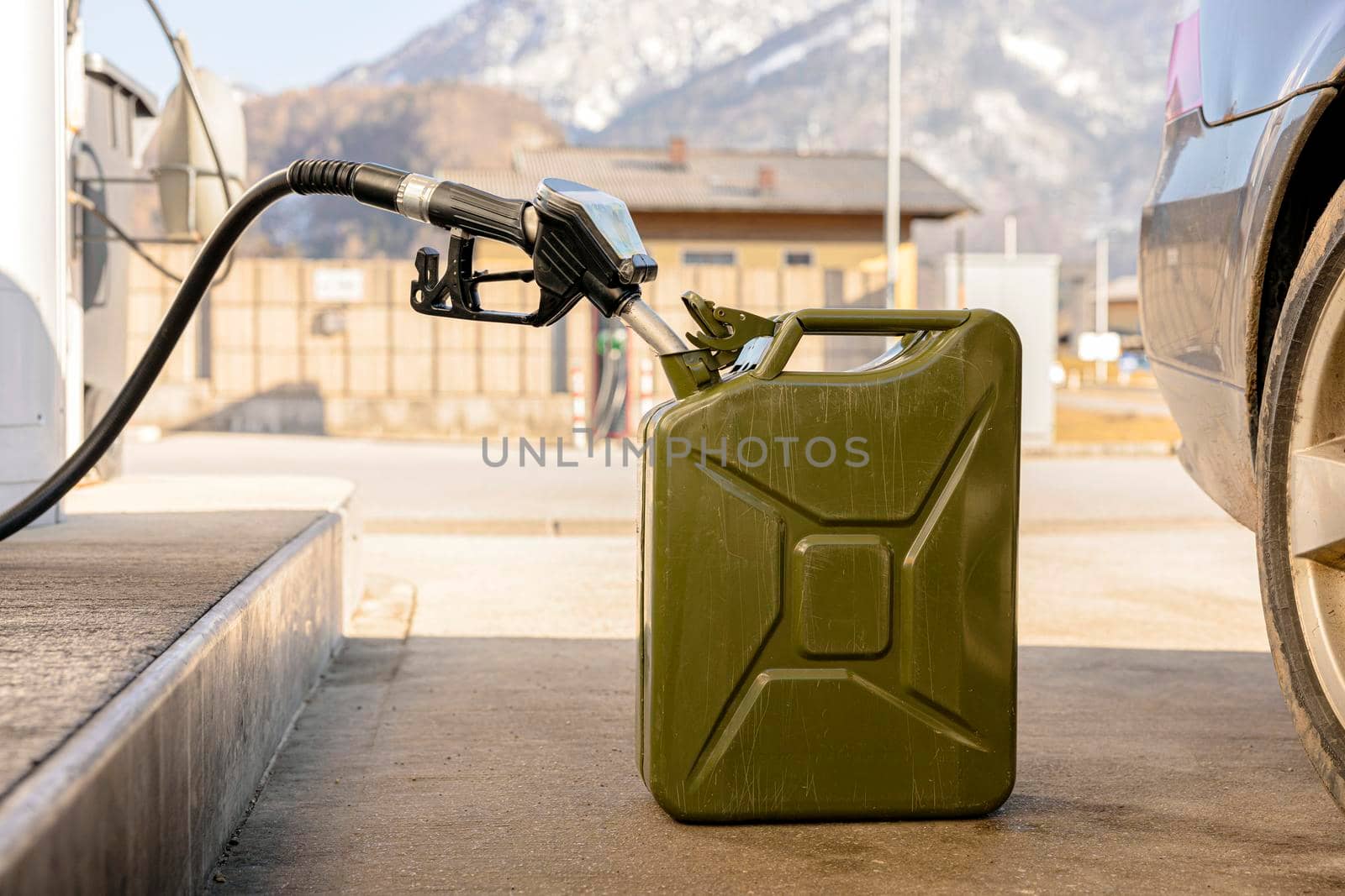 Refilling canister with fuel on the petrol station. Close up view. Fuel, gasoline, diesel is getting more expensive. Petrol industry and service. Petrol price and oil crisis concept