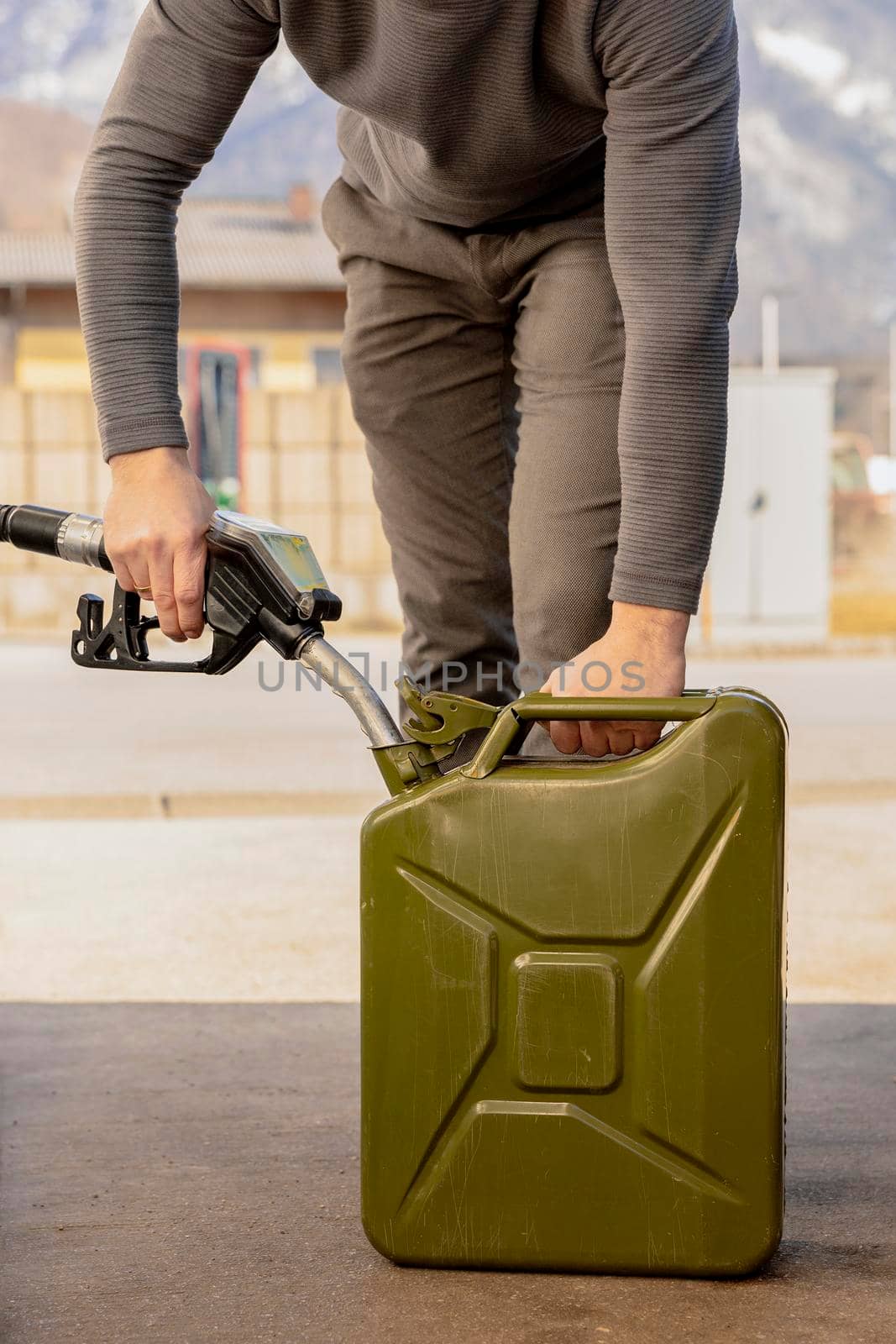 Refilling canister with fuel on the petrol station. Close up view. Fuel, gasoline, diesel is getting more expensive. Petrol industry and service. Petrol price and oil crisis concept